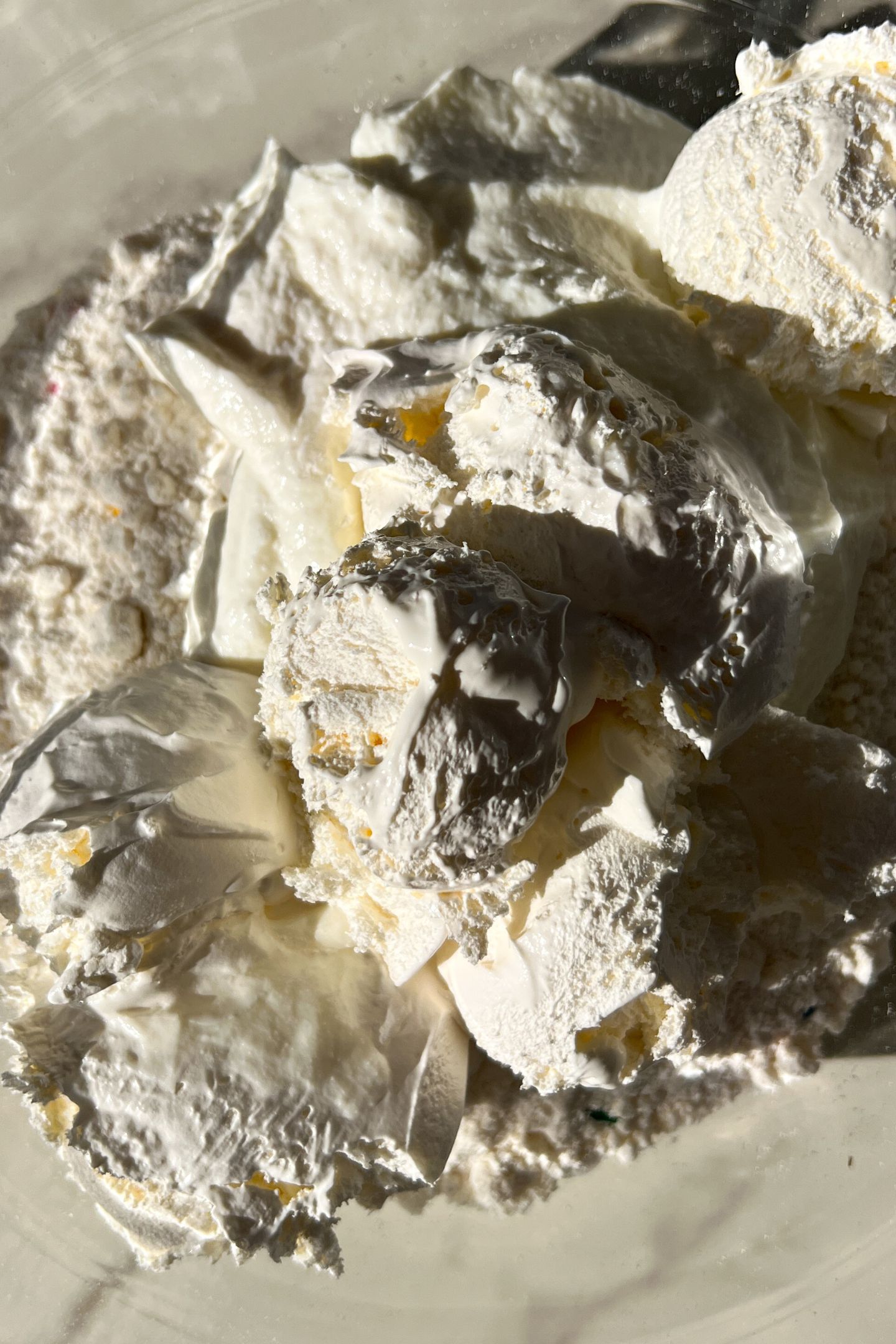 Cake mix, cool whip and greek yogurt in a bowl.