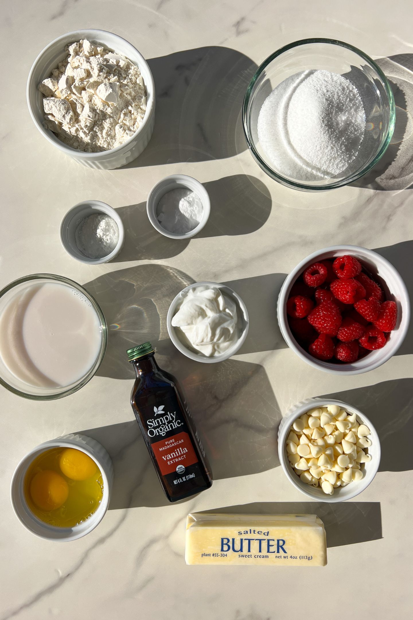 Ingredients measured out in bowls to make the raspberry and white chocolate muffins.
