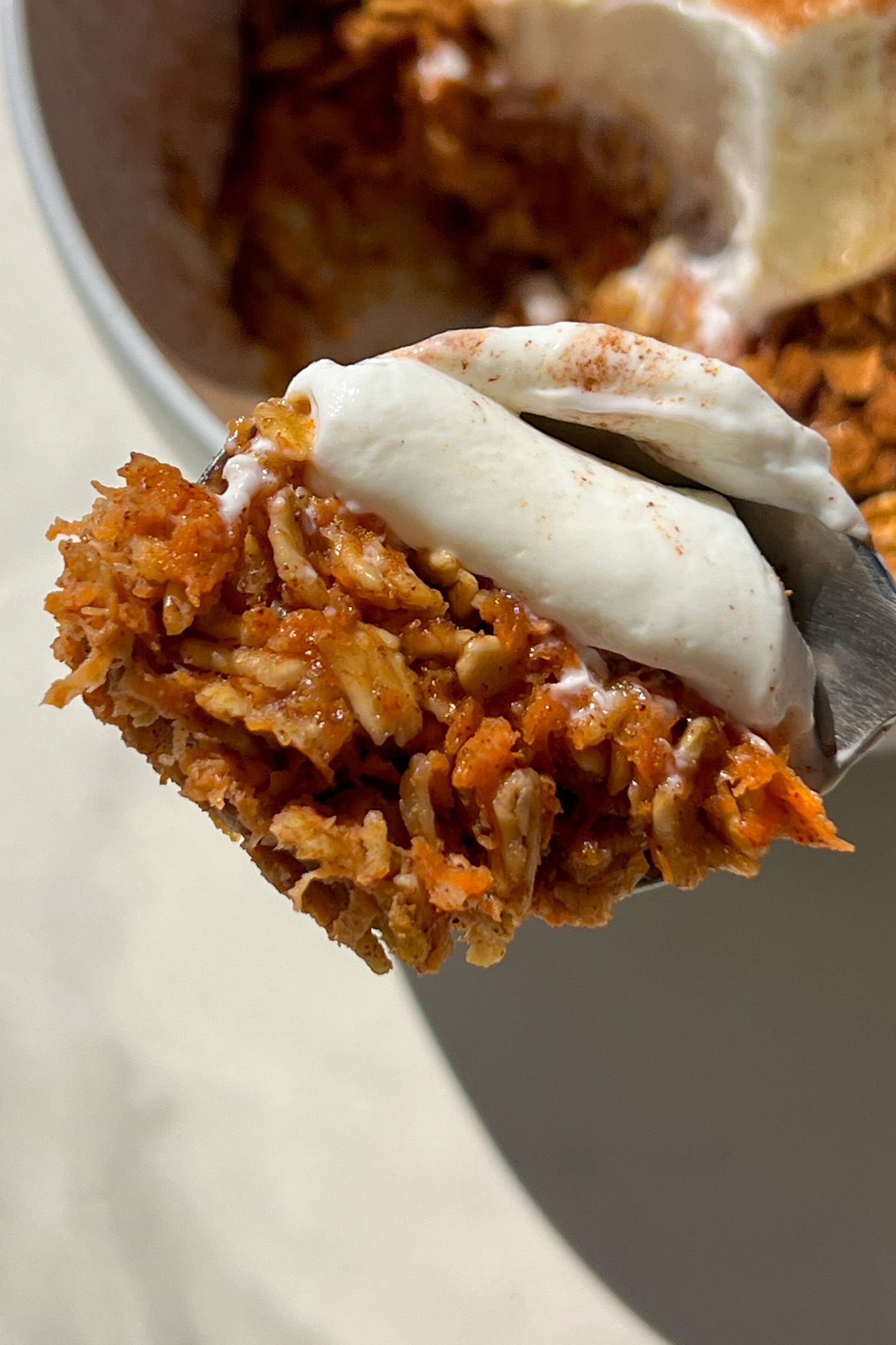 A spoonful of carrot cake oatmeal with greek yogurt.
