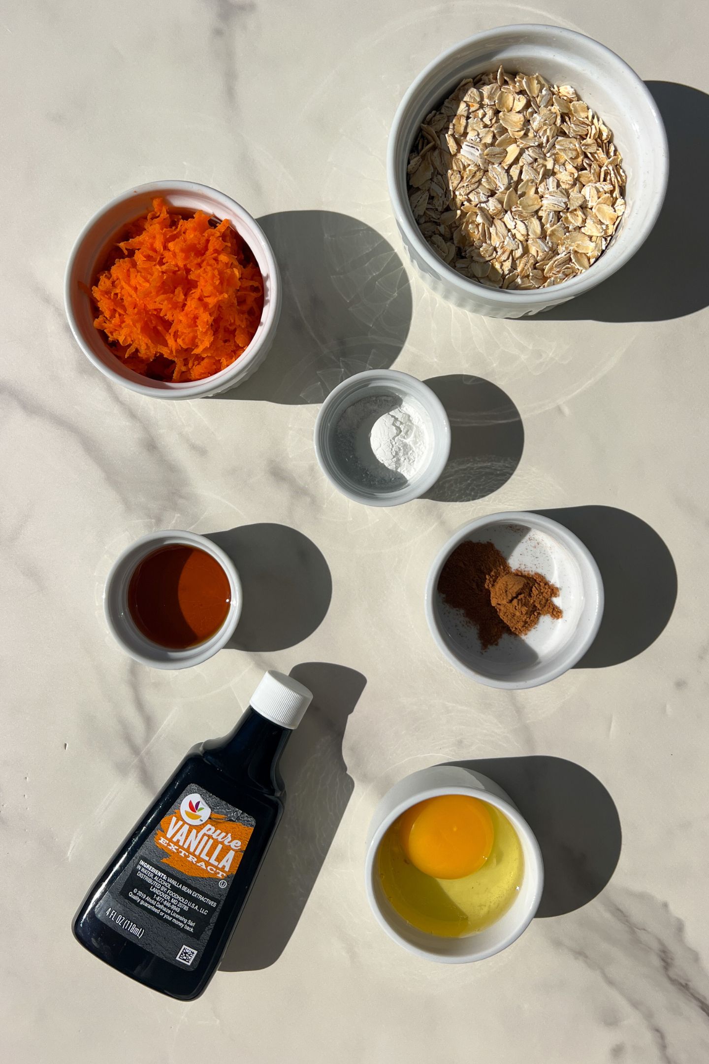 Ingredients measured out in bowls to make carrot cake oatmeal.