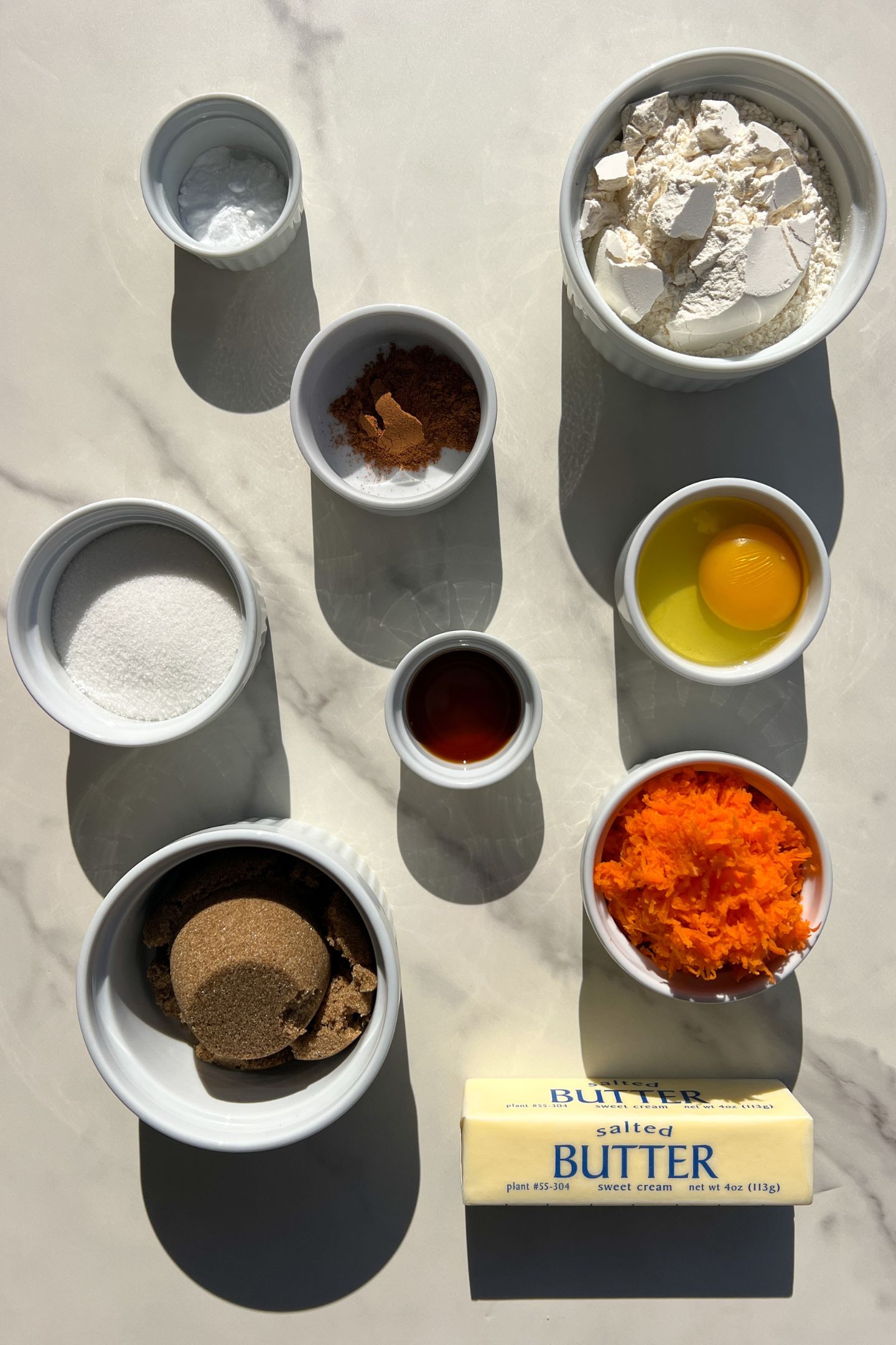 Ingredients measured out in bowls to make carrot cookies.