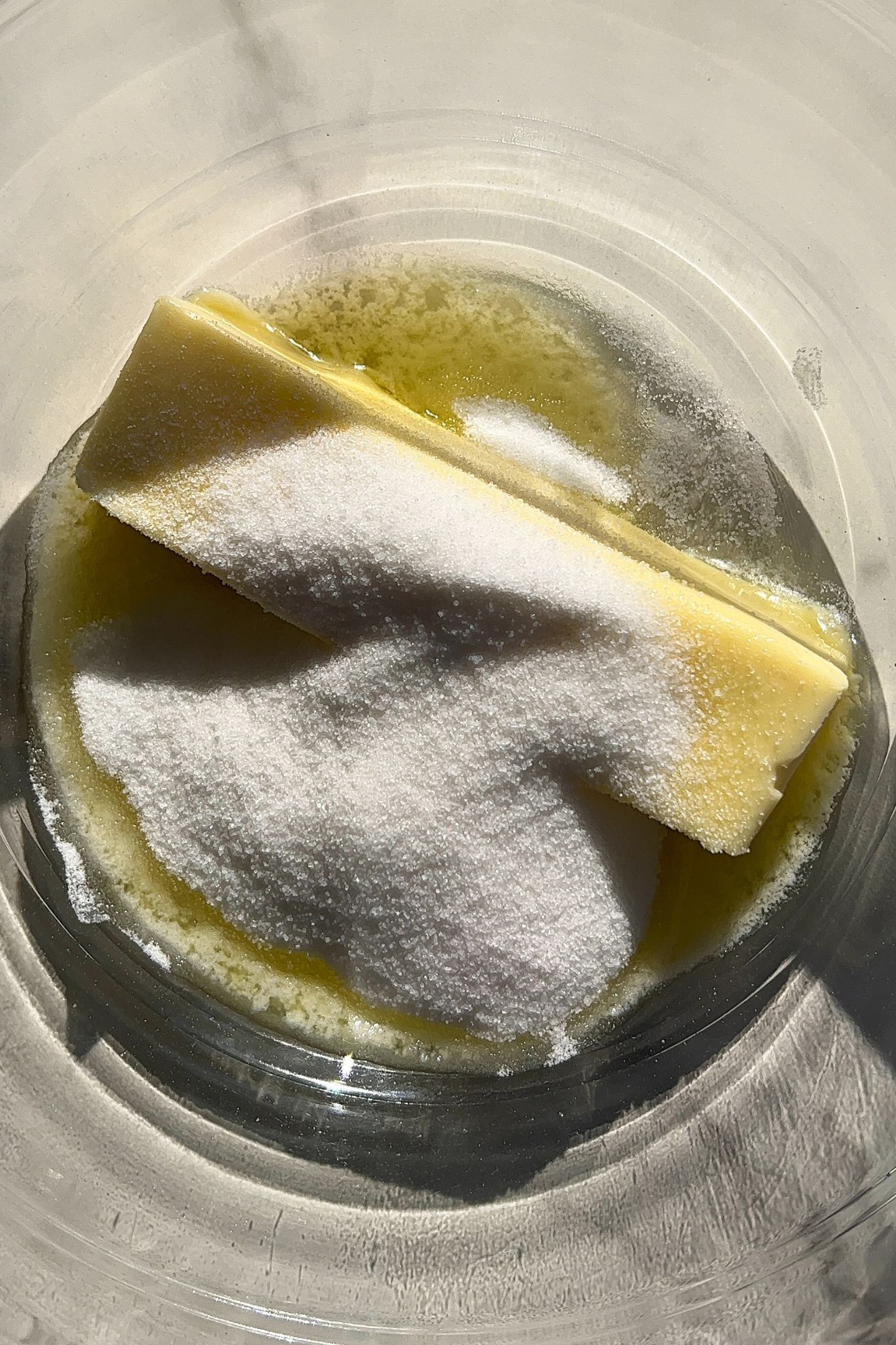 Softened butter in a bowl with granulated sugar.