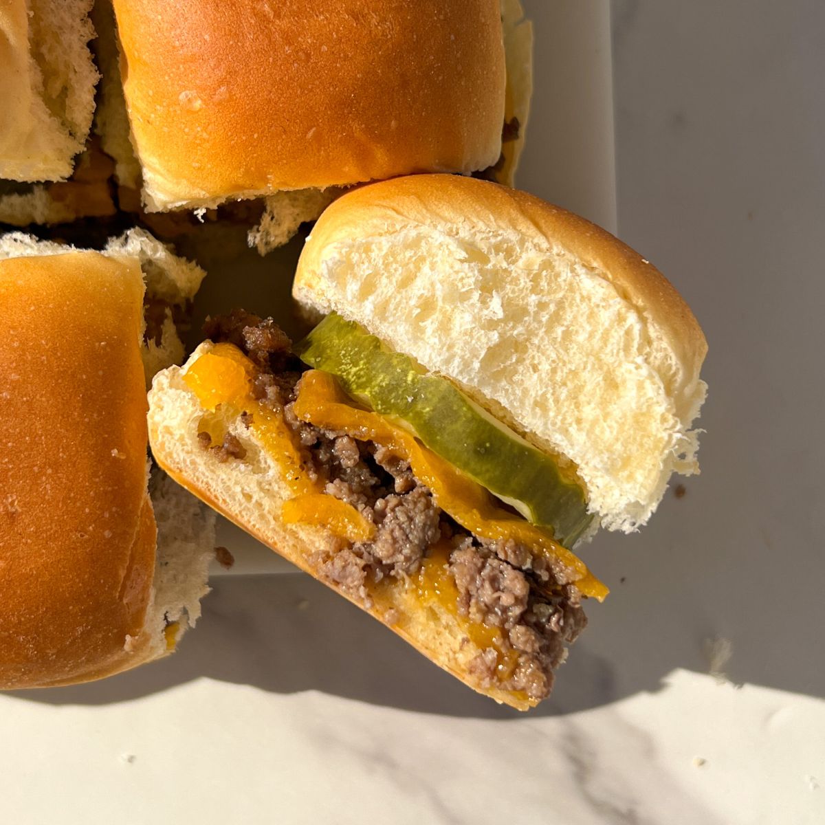 Cheeseburger Slider on its side on a platter.