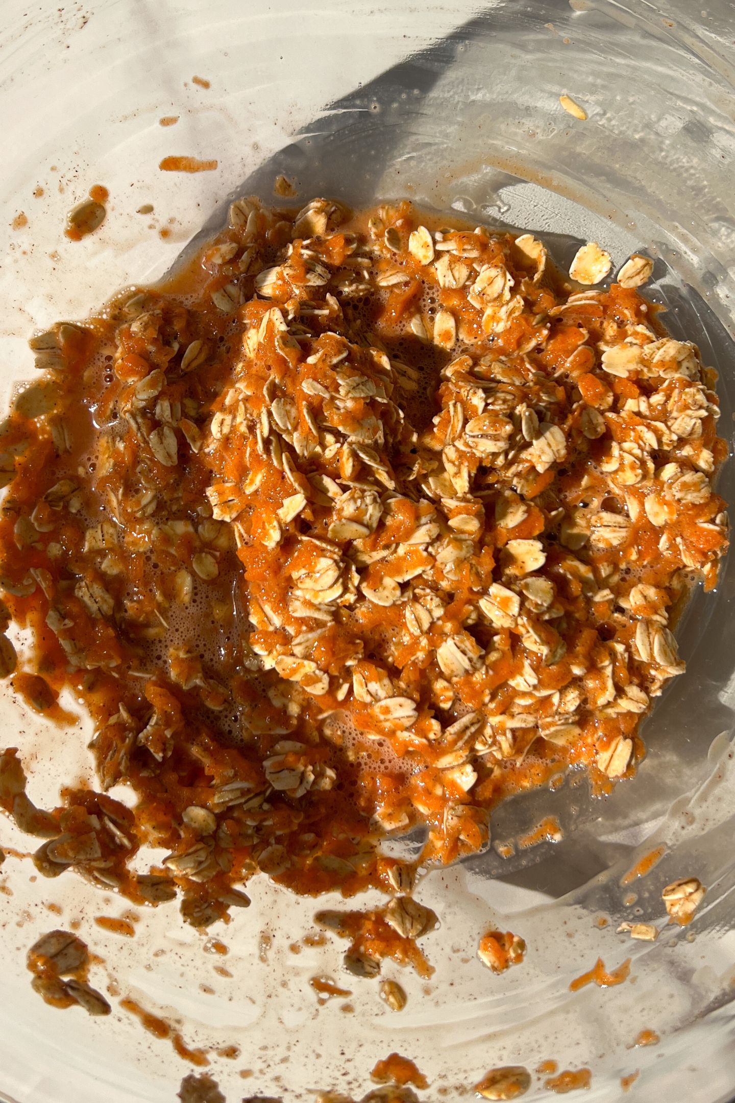 Baked oats ingredients mixed together in a bowl.