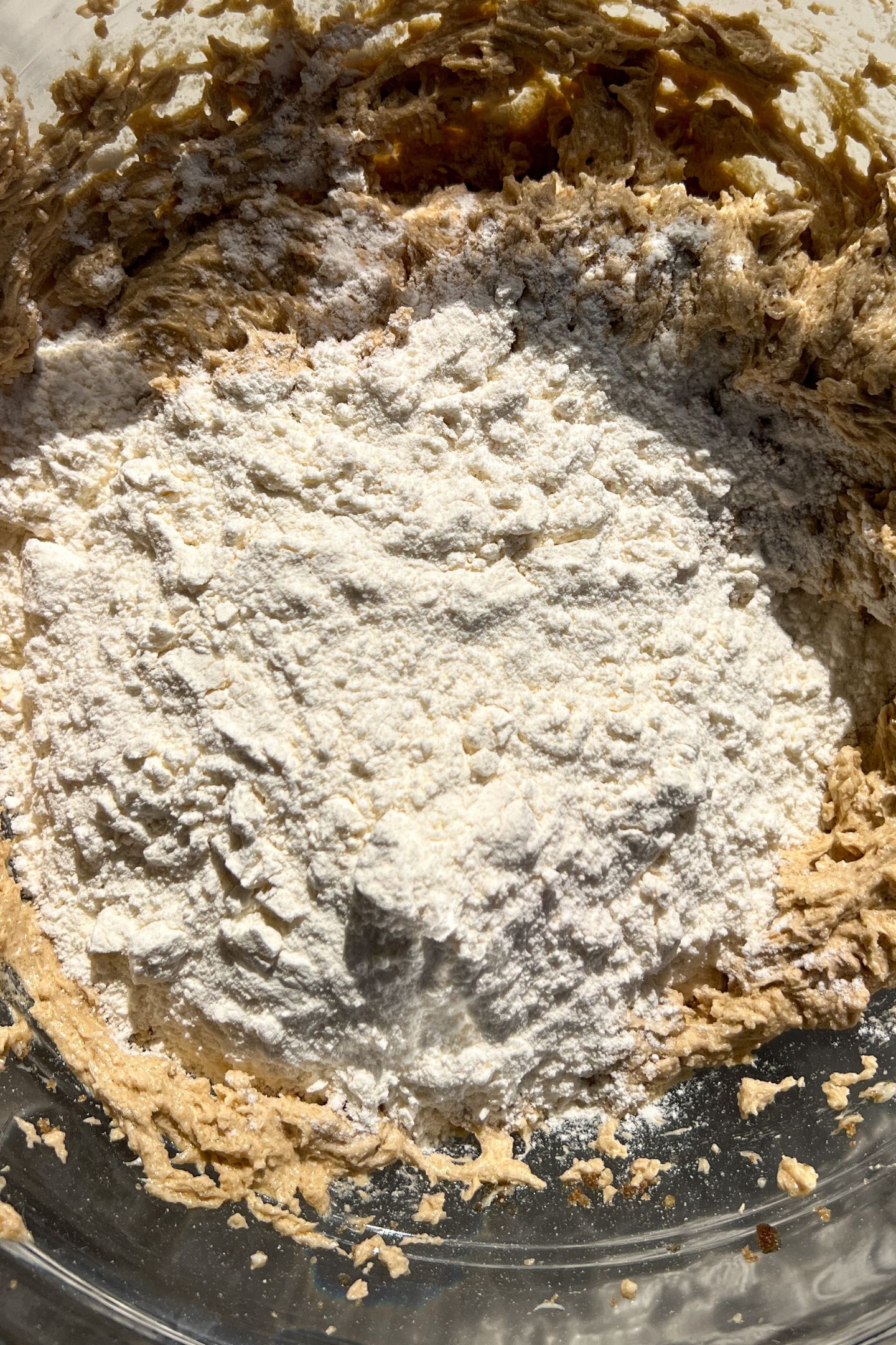 Adding dry ingredients to batter.