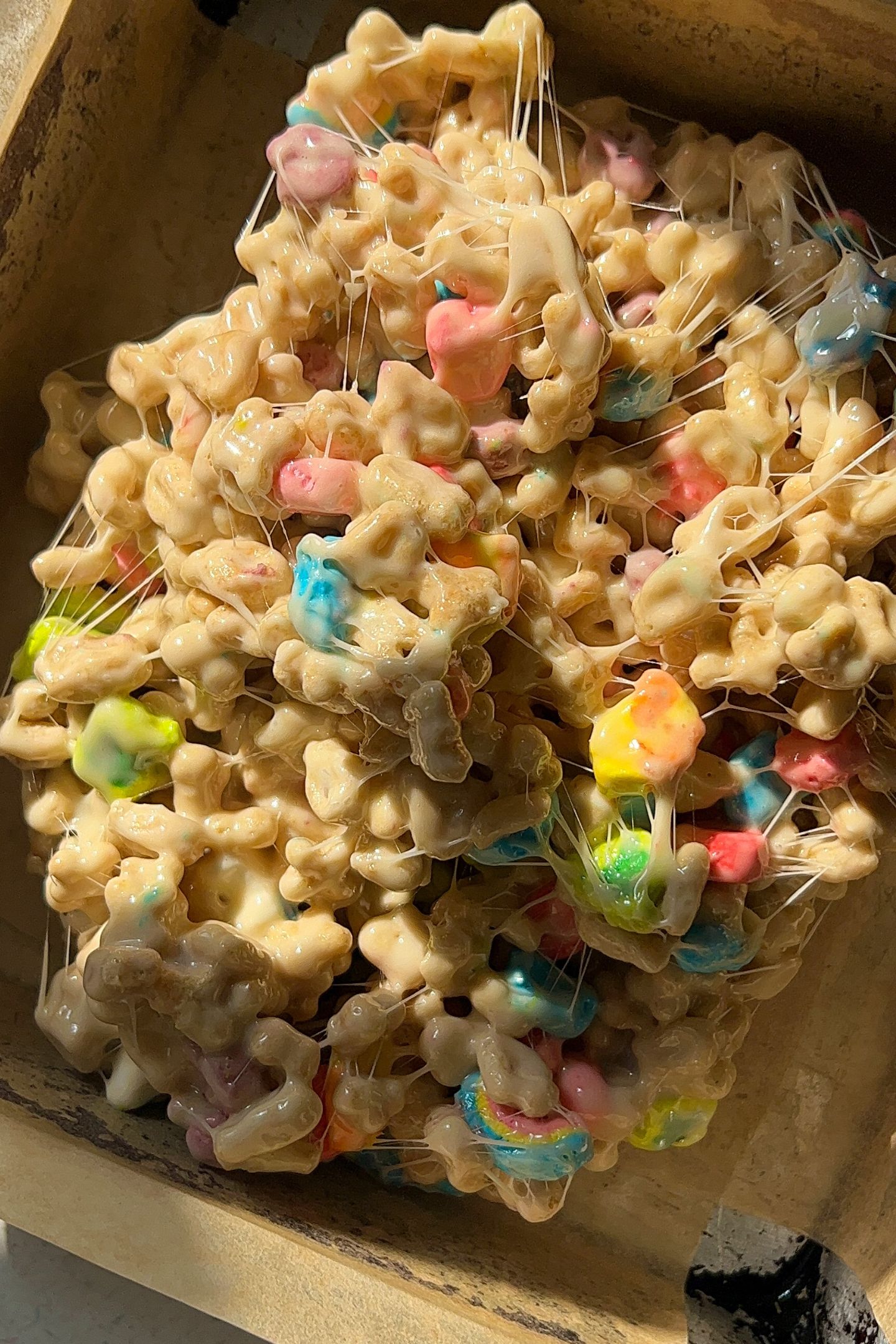 Transfer the Lucky Charms Rice Krispie Treats to the prepared pan.