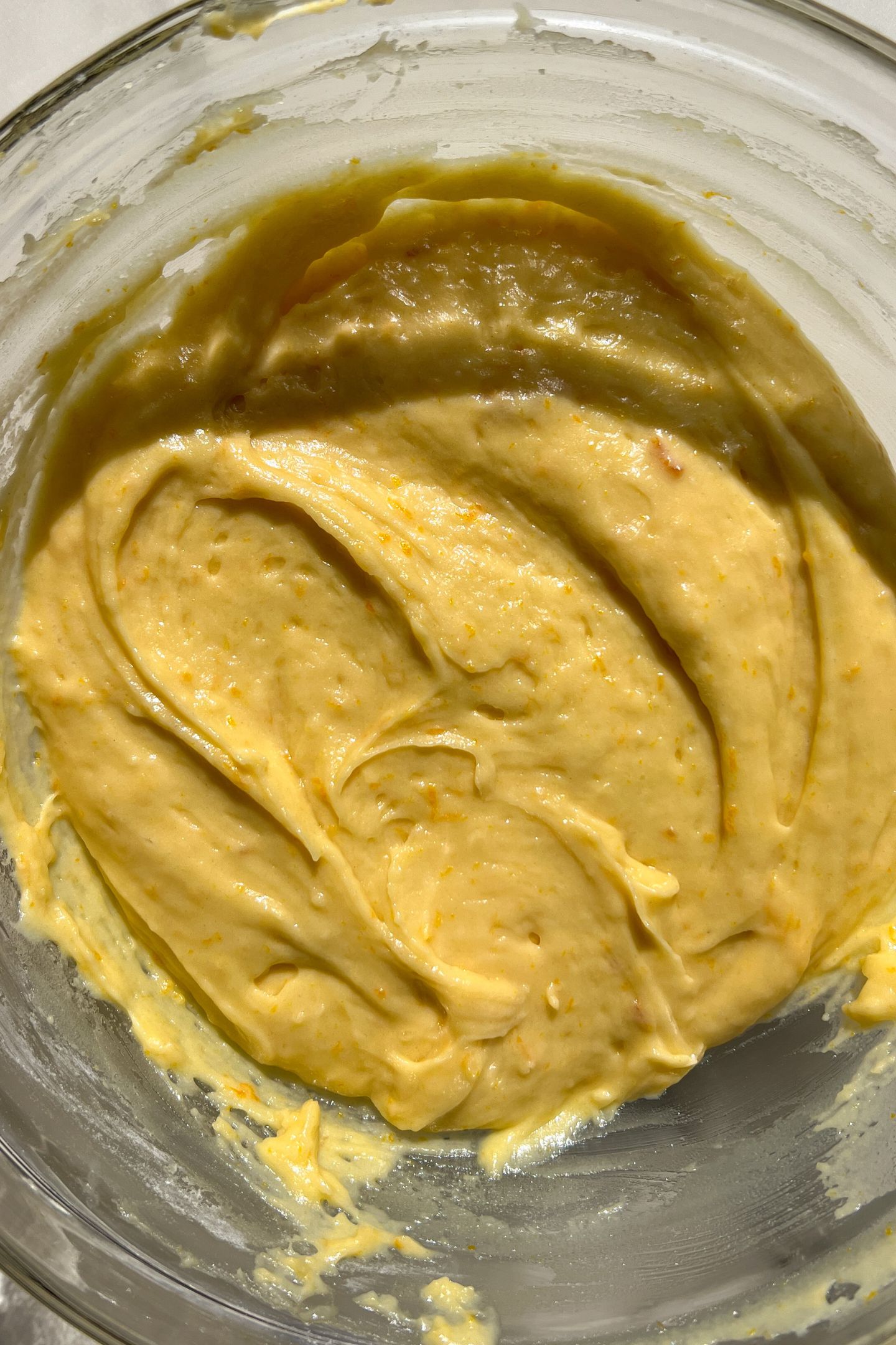 Orange loaf batter in a mixing bowl.