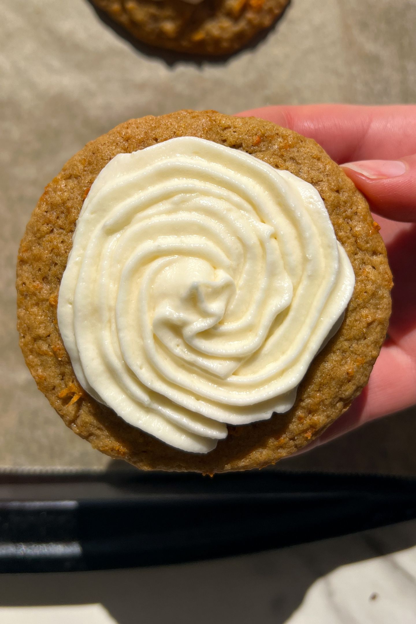 Holding a carrot cake cookie in my hand.