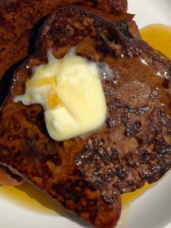 Cinnamon Raisin French Toast topped with butter and maple syrup.