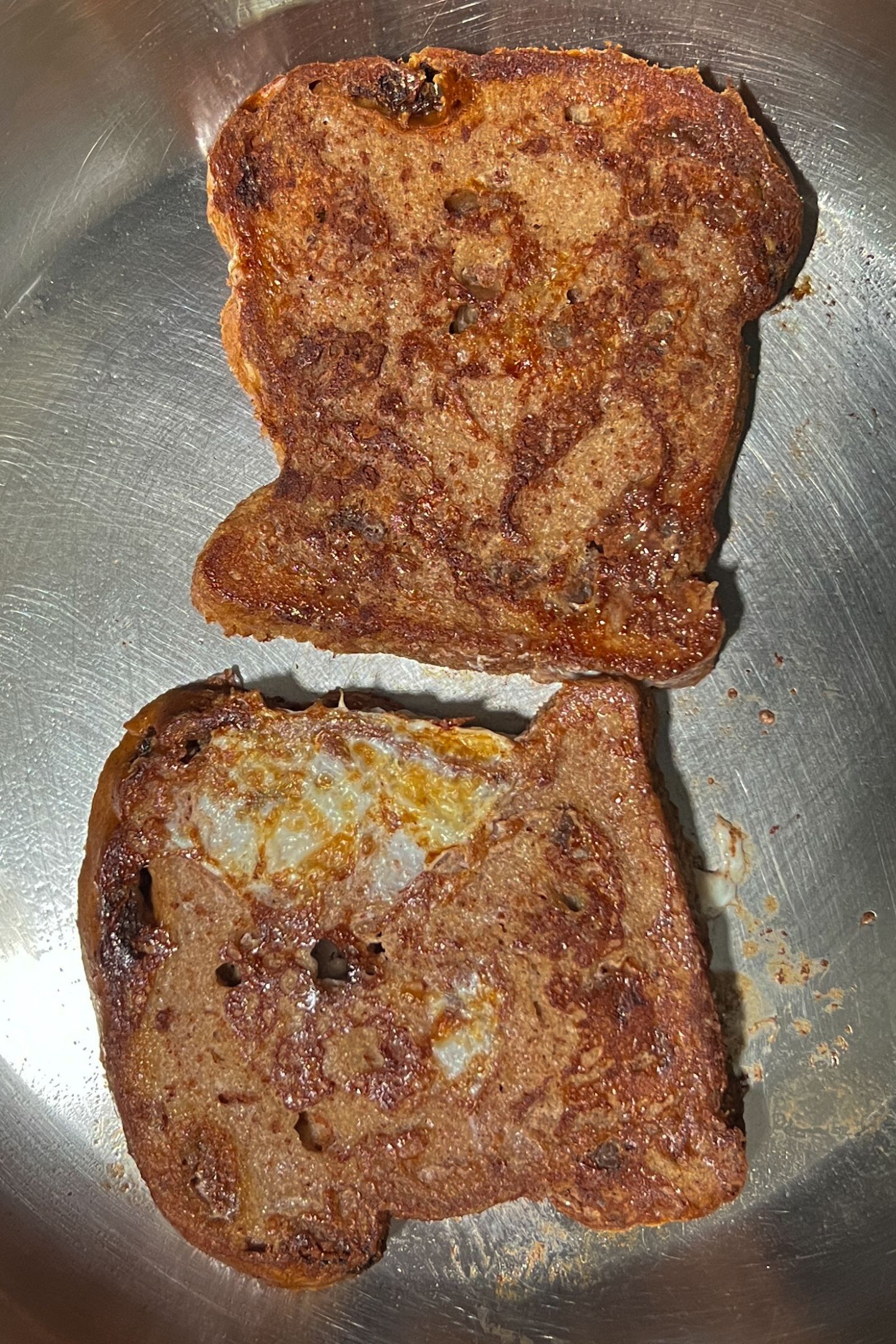Cooked French toasted in a heated pan.
