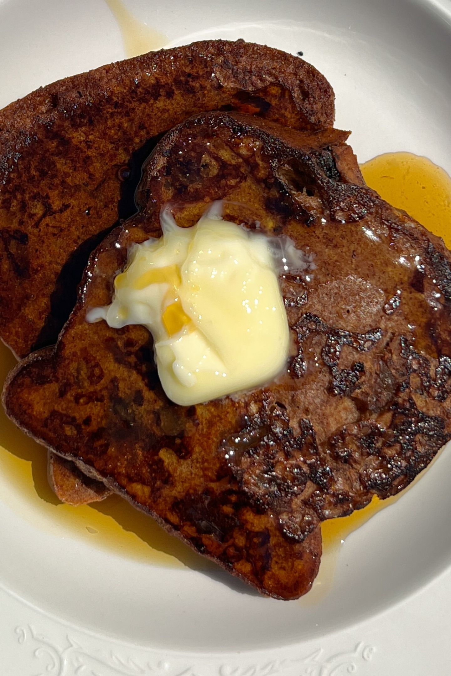 Cinnamon Raisin French Toast topped with butter and maple syrup.