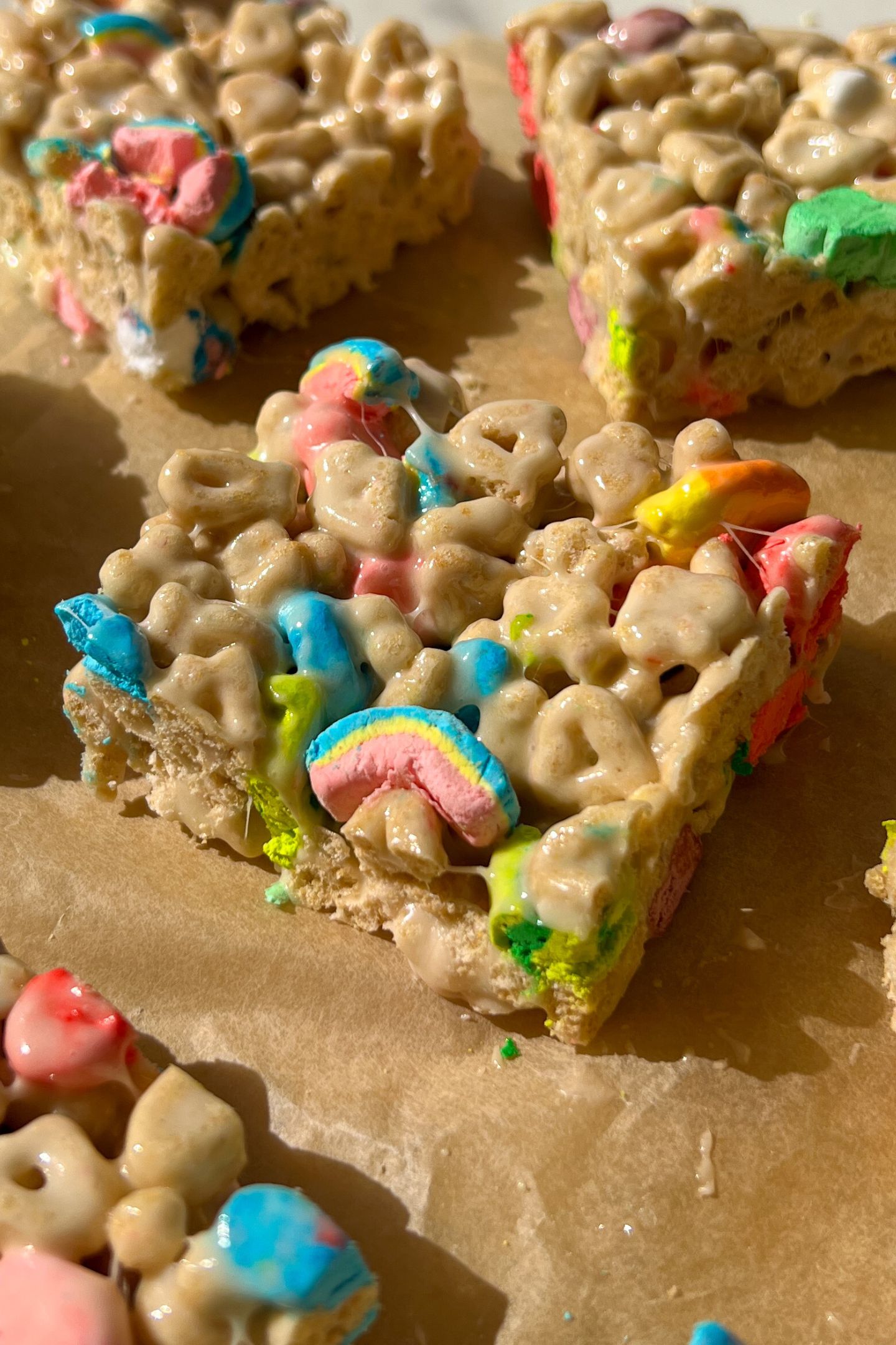 Sliced Rice Krispie Treats made with Lucky Charms cereal on a serving platter.