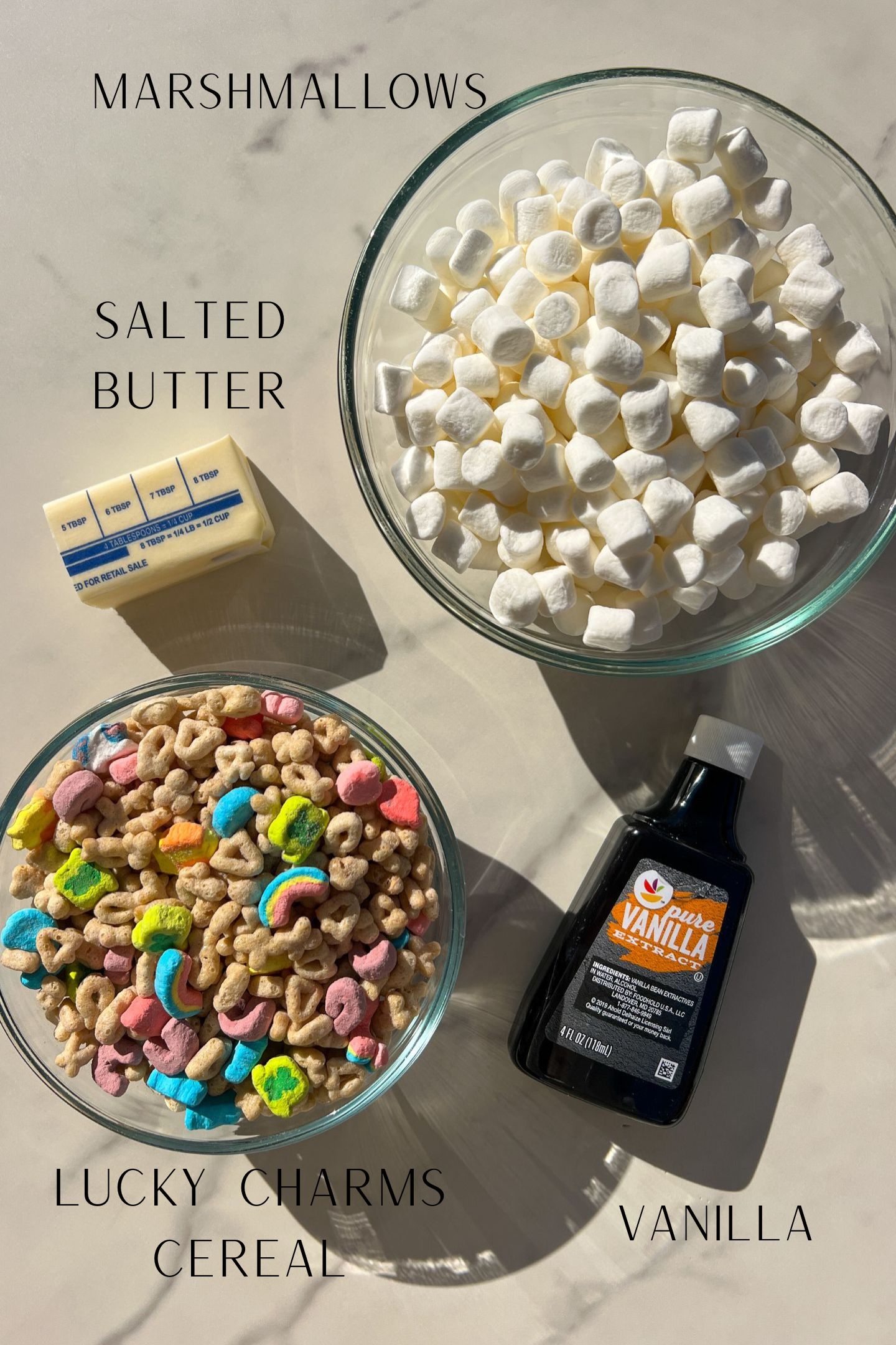 Ingredients measured out in bowls to make Lucky Charms Rice Krispie Treats.