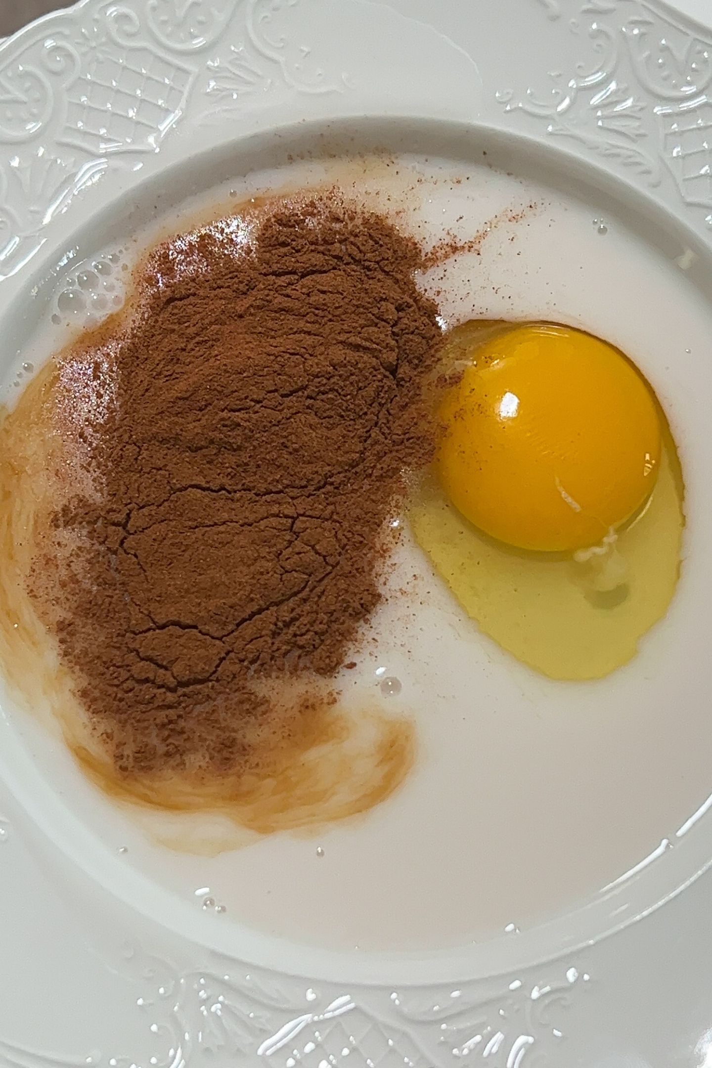 Egg mixture in a bowl with cinnamon.