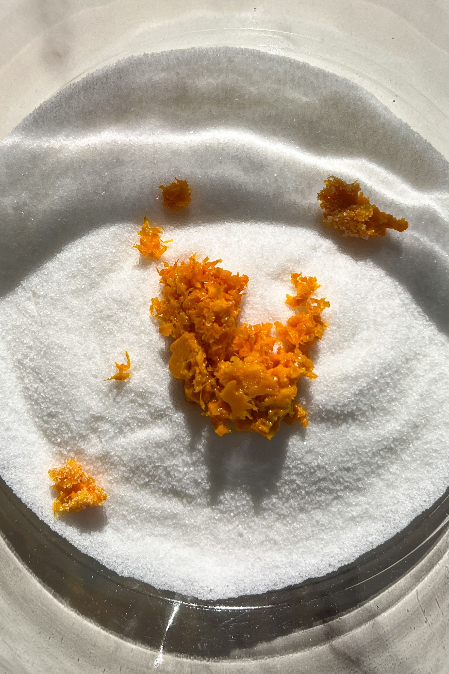 Granulated sugar and orange zest in a large mixing bowl.