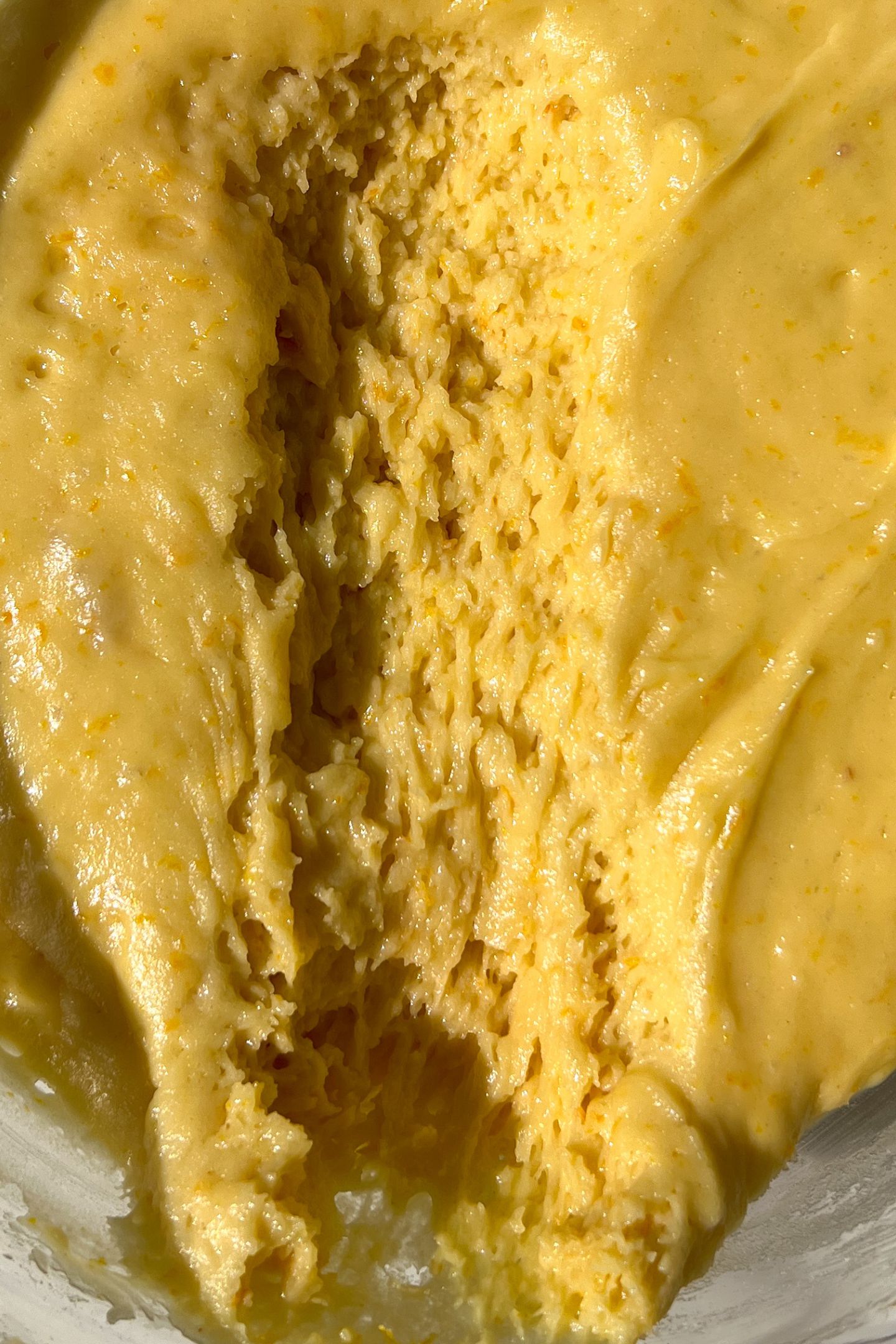 Scooping out the dough from the bowl.