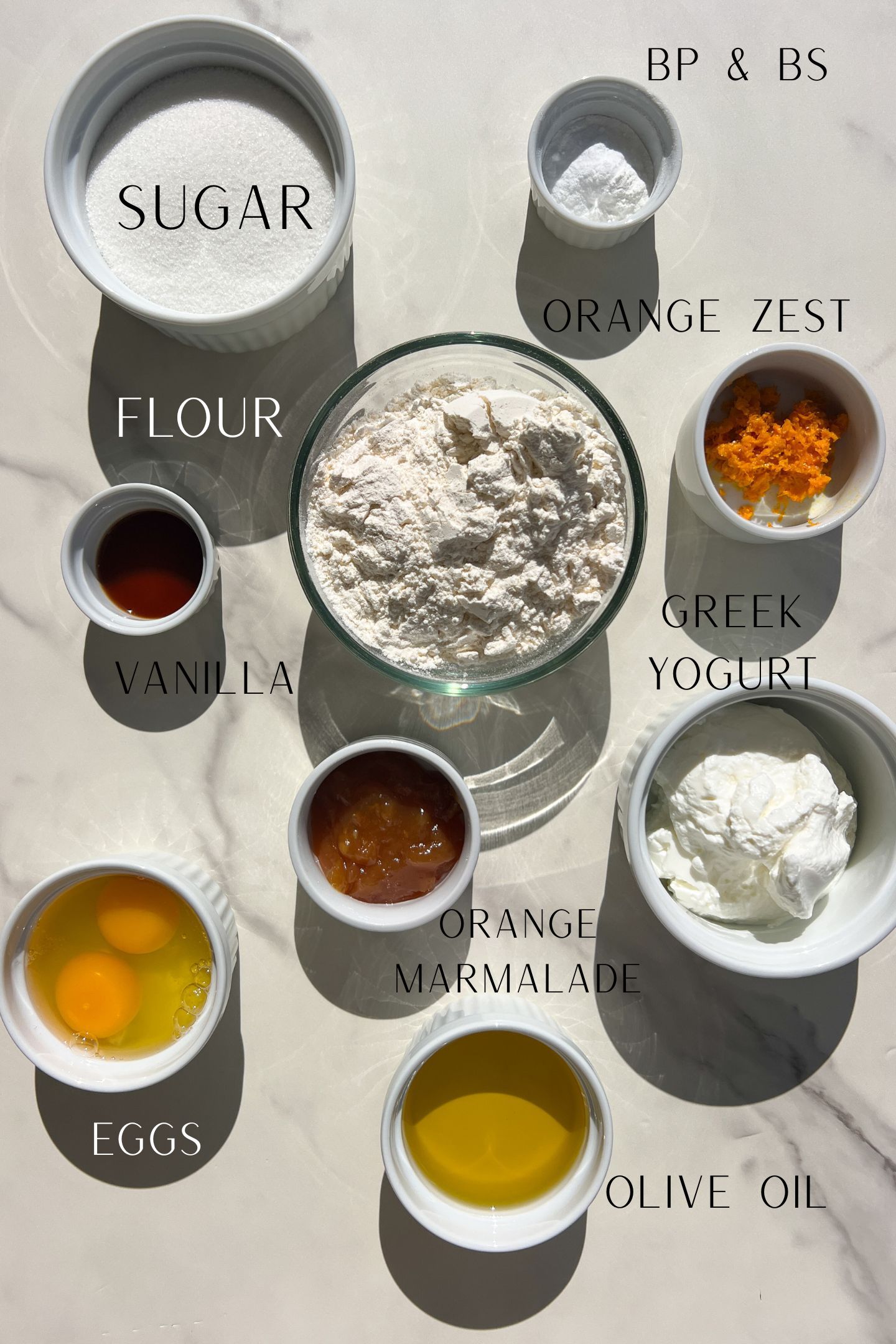 Ingredients measured out in bowls to make the orange loaf cake.