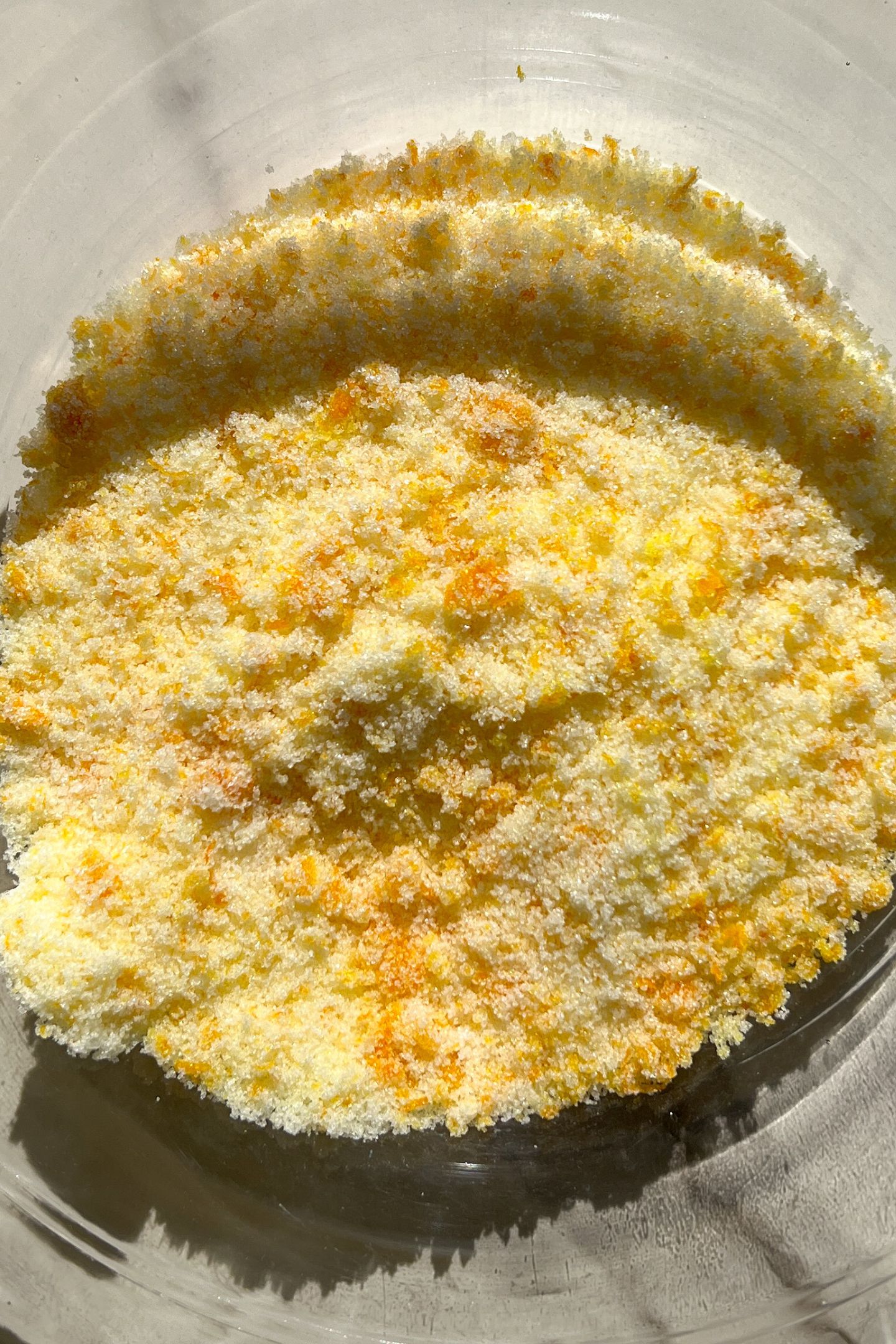 Granulated sugar and orange zest in a large mixing bowl.