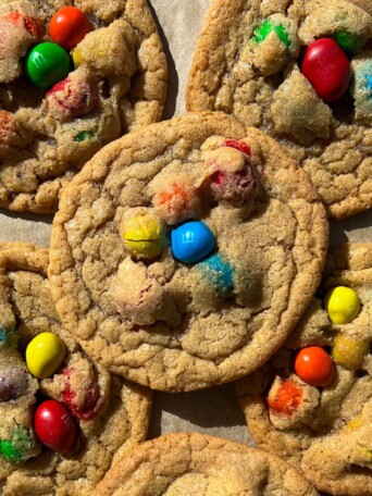 Peanut M&M Cookies on a baking sheet lined with parchment paper.