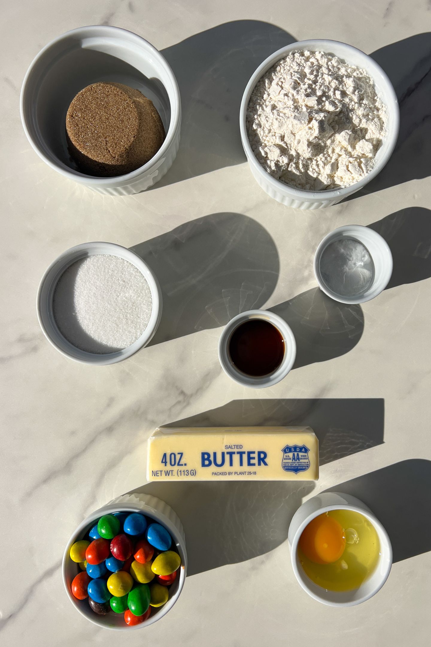 Ingredients measured out in bowls to make peanut chocolate candy cookies.