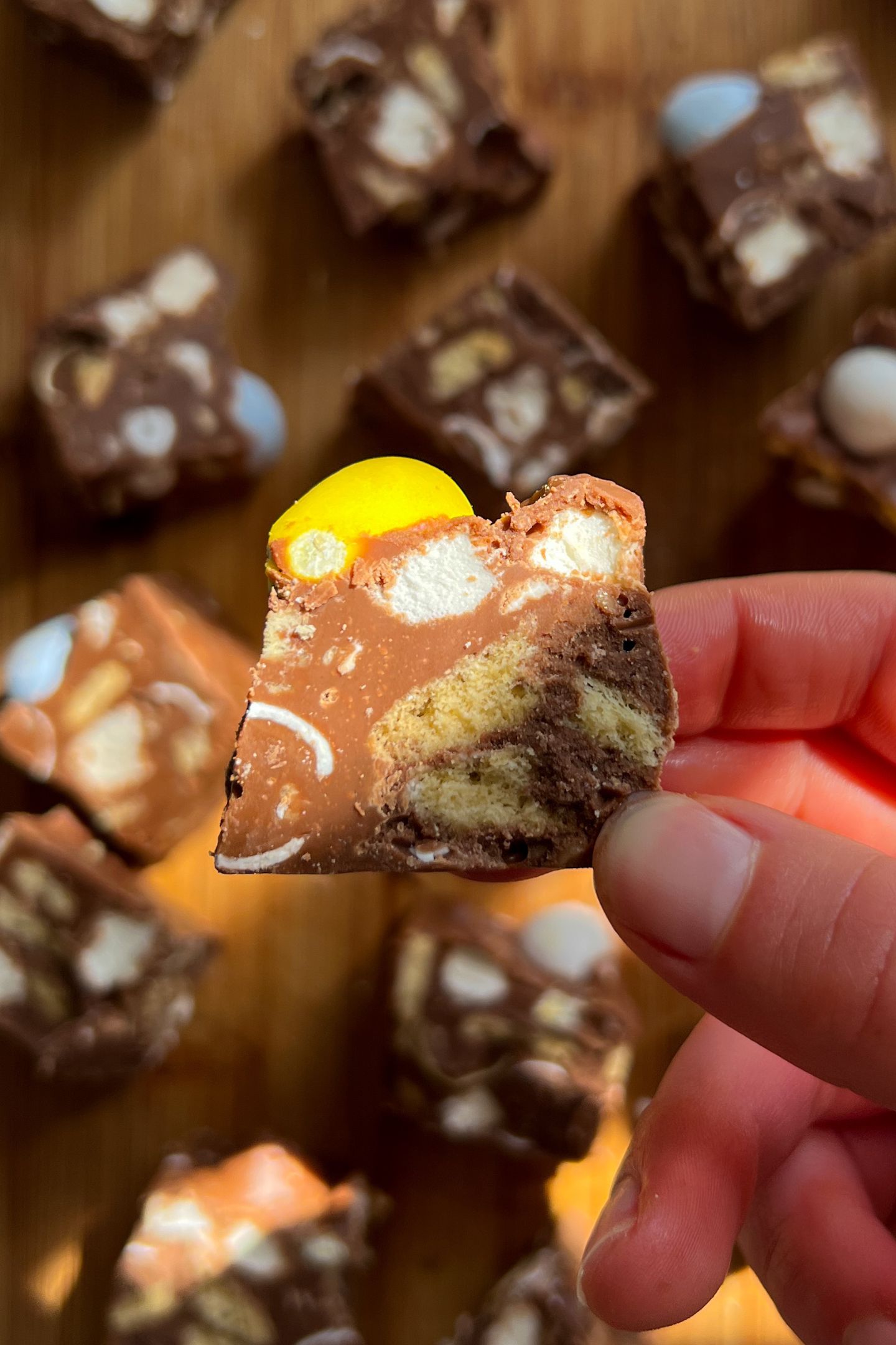 Holding a piece of Easter Rocky Road candy in my hand.