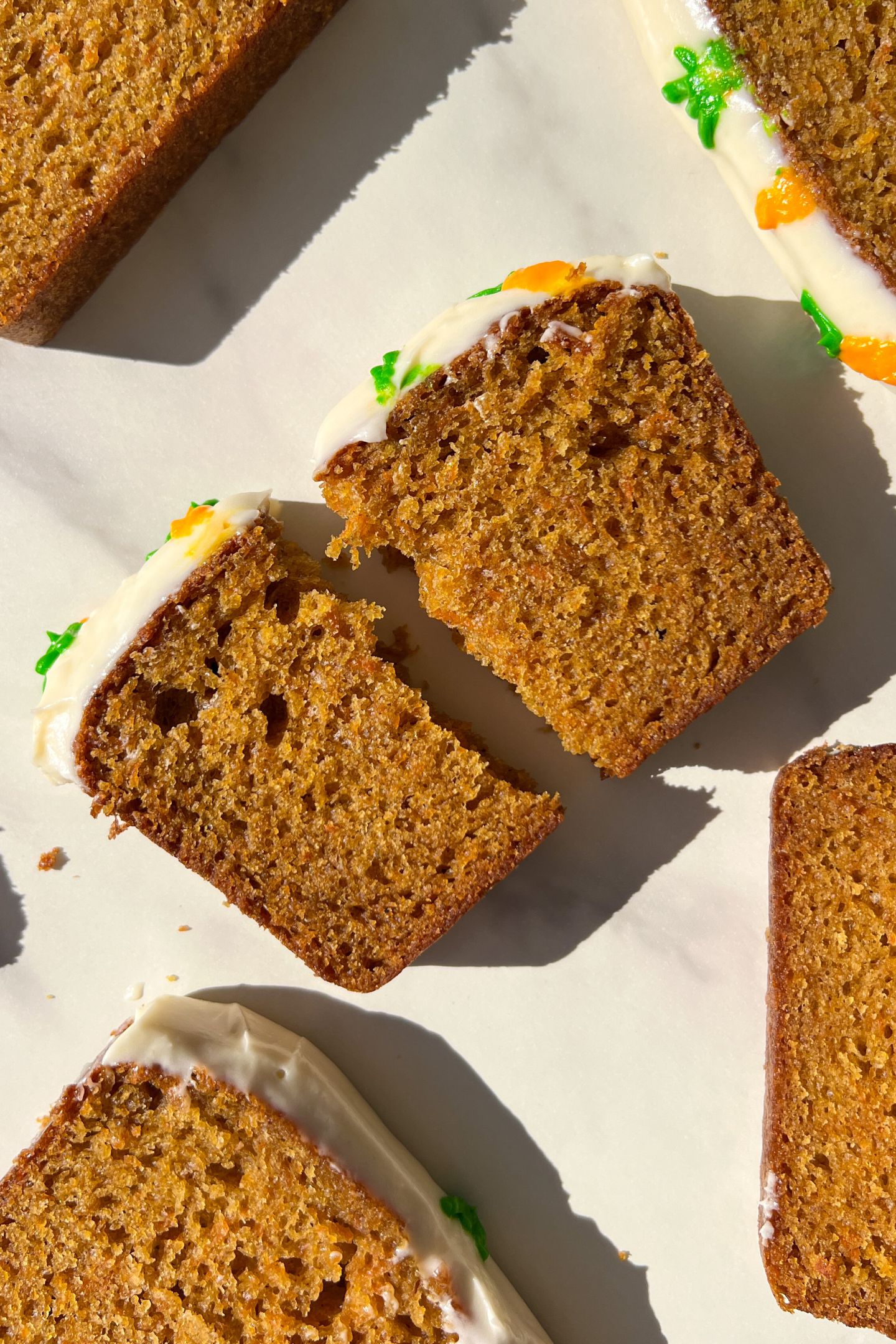 A slice of Carrot Cake Loaf broken in half.