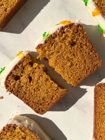 A slice of Carrot Cake Loaf broken in half.
