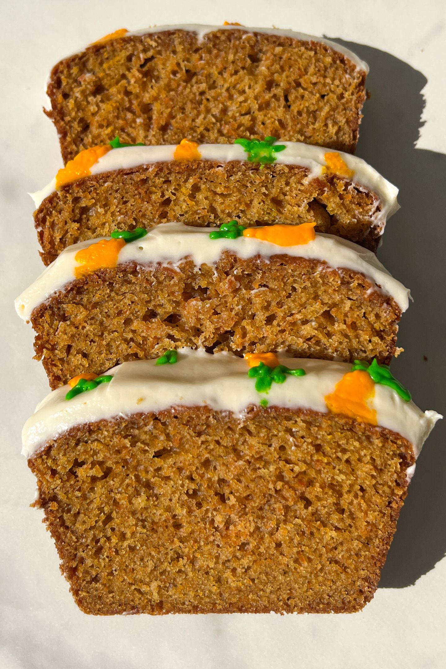 Slices of carrot loaf cake on a serving platter.