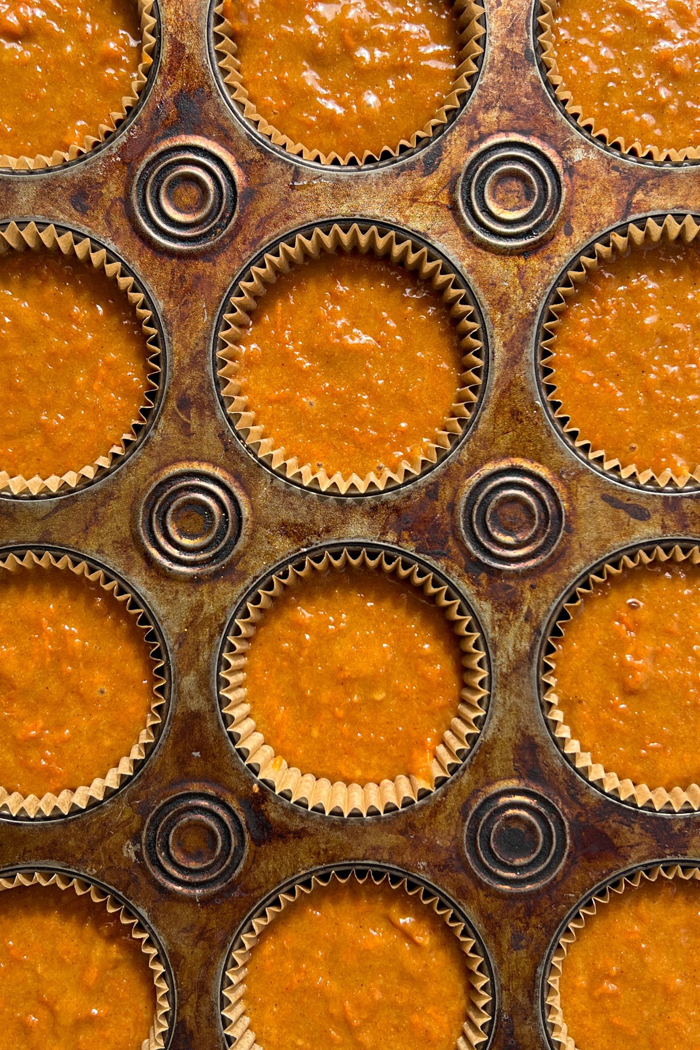 Carrot cake cupcake batter in cupcakes liners.