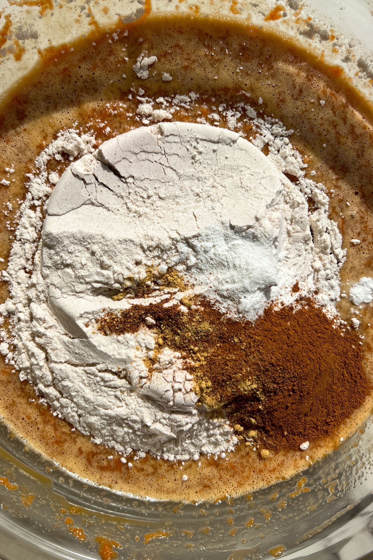 Dry ingredients on top of wet ingredients in mixing bowl.
