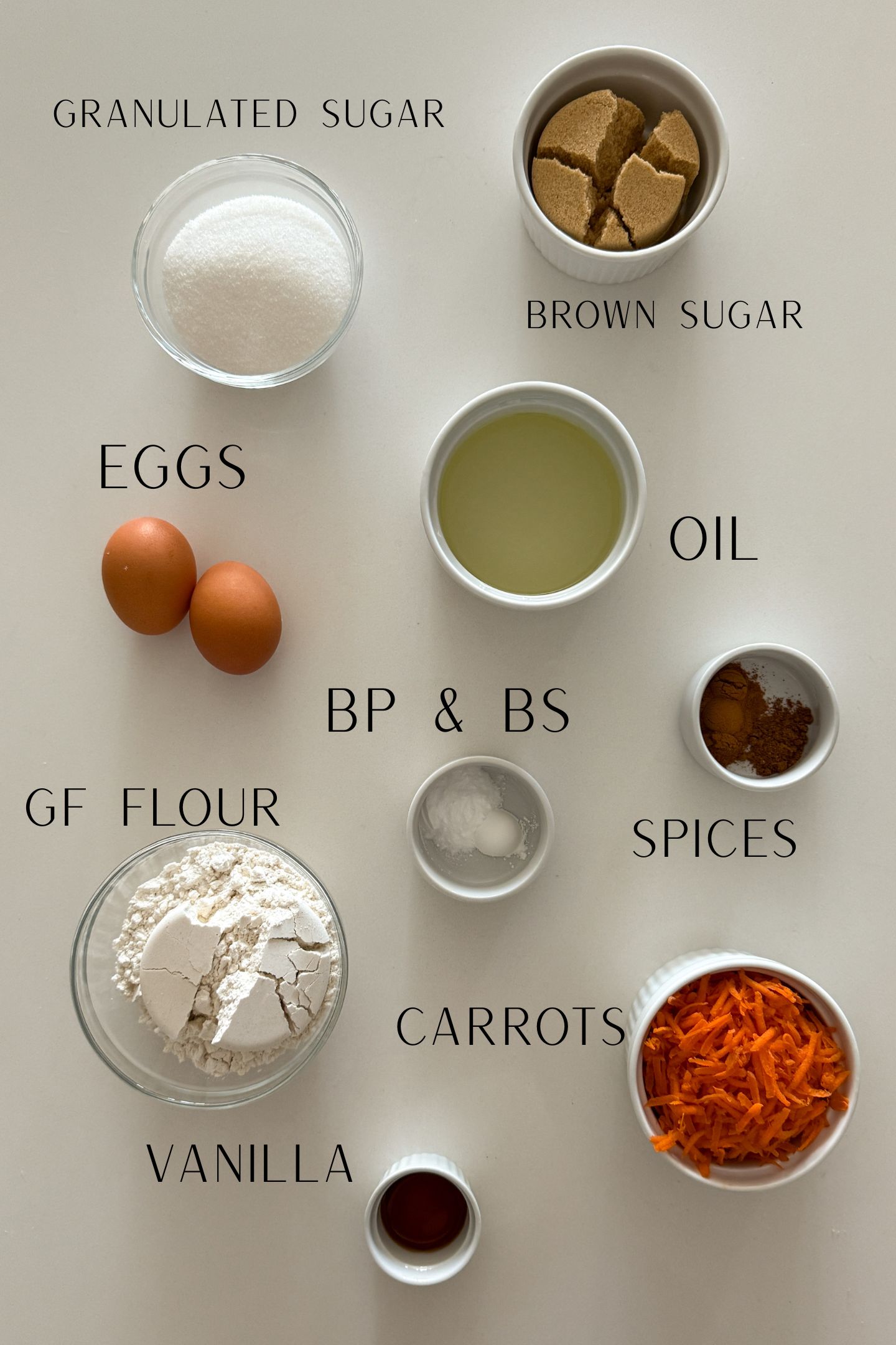 Ingredients measured out in bowls to make the gluten free carrot cake cupcakes.
