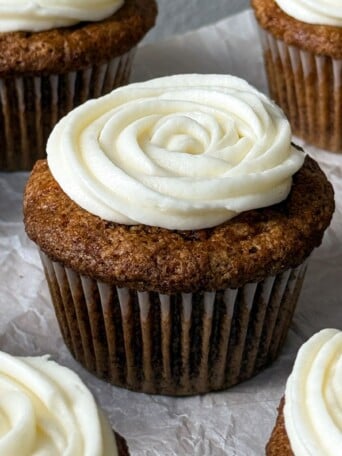Carrot cake cupcake topped with frosting.
