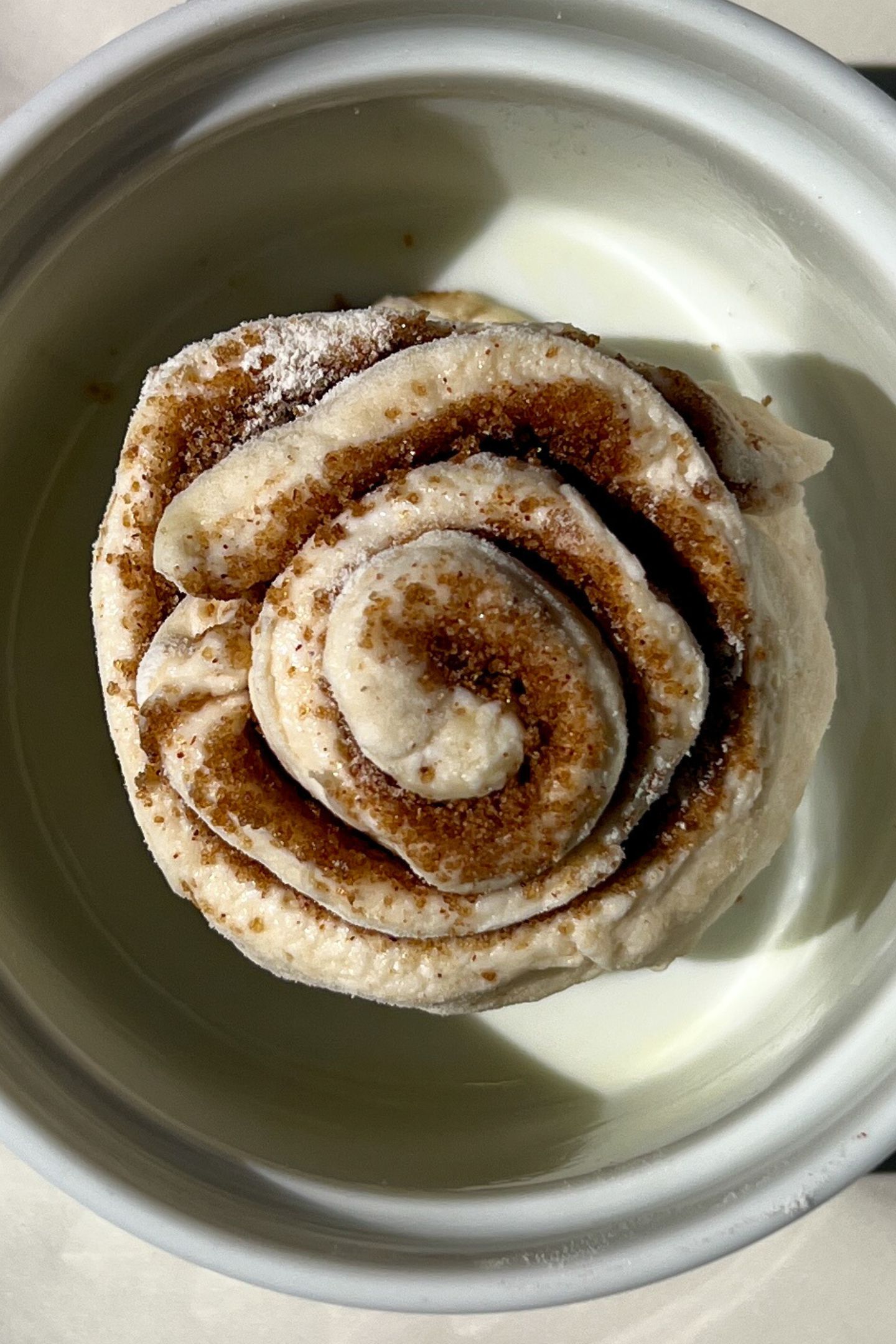 Cinnamon roll in a greased dish.