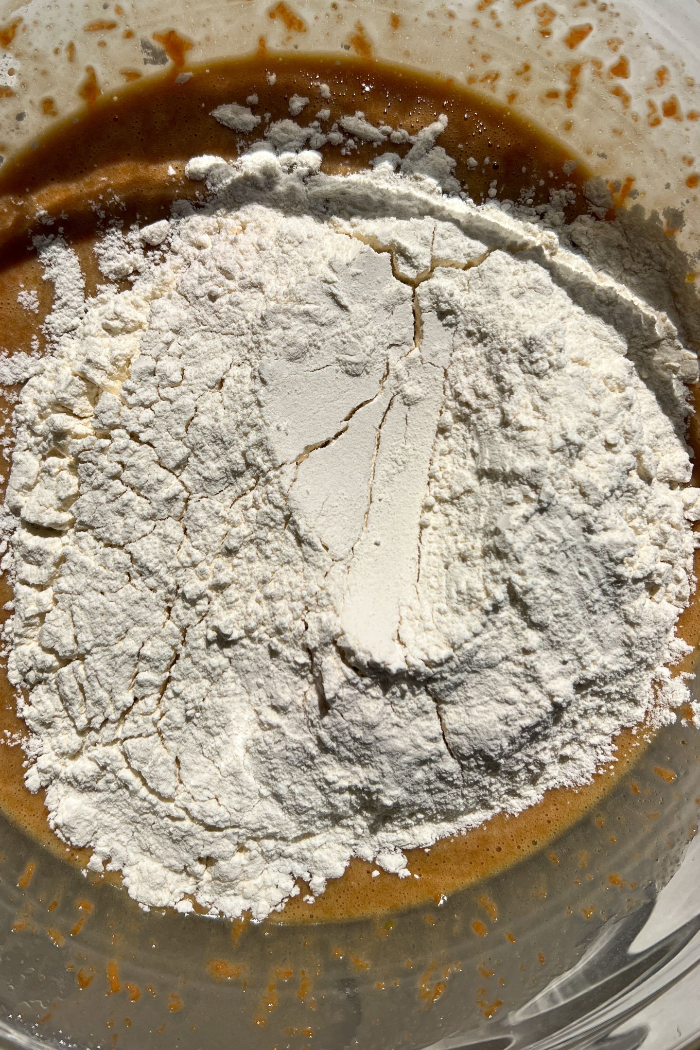 Adding dry ingredients to the mixing bowl.