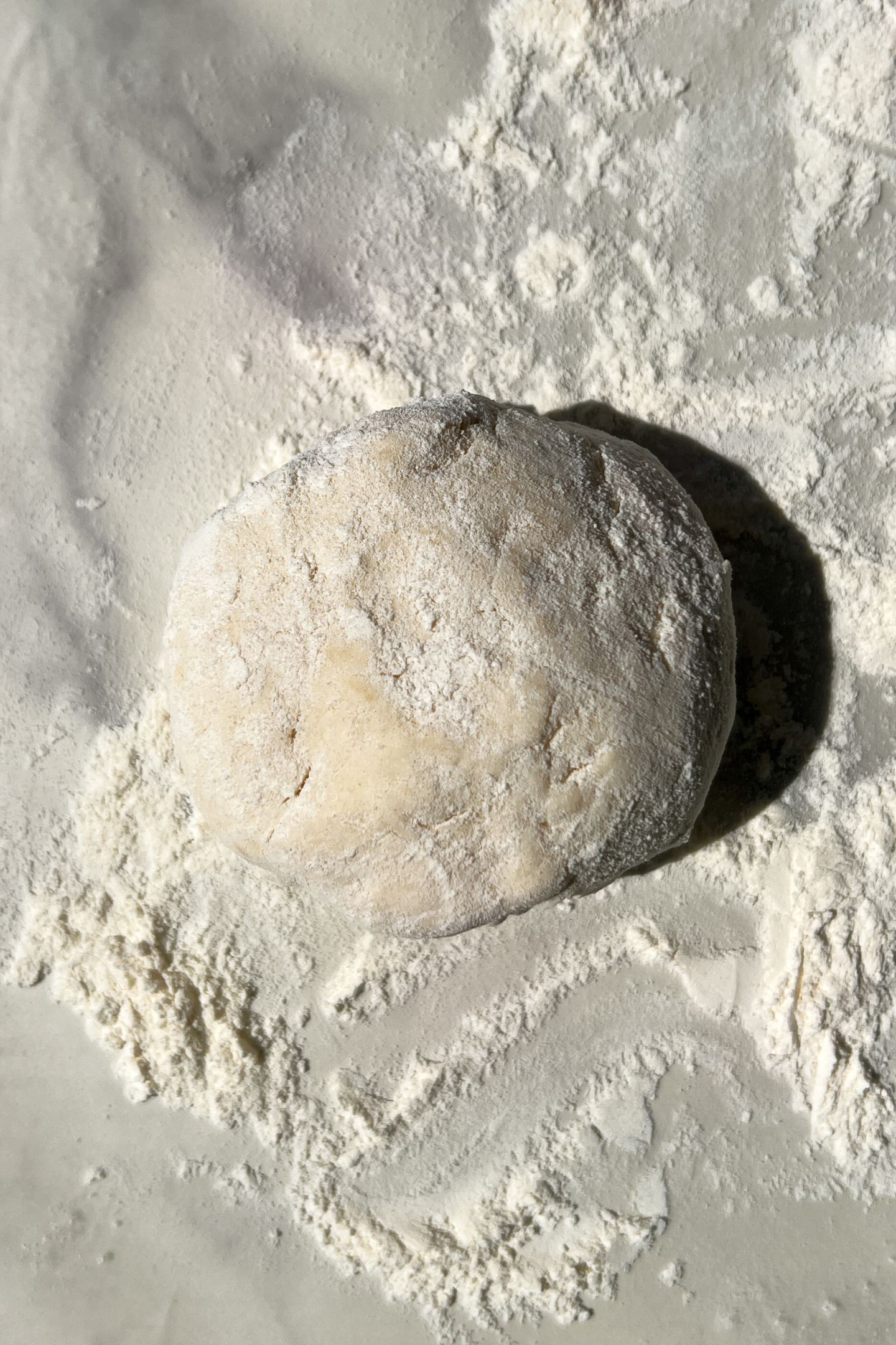 Ball of dough on floured surface to be rolled out.