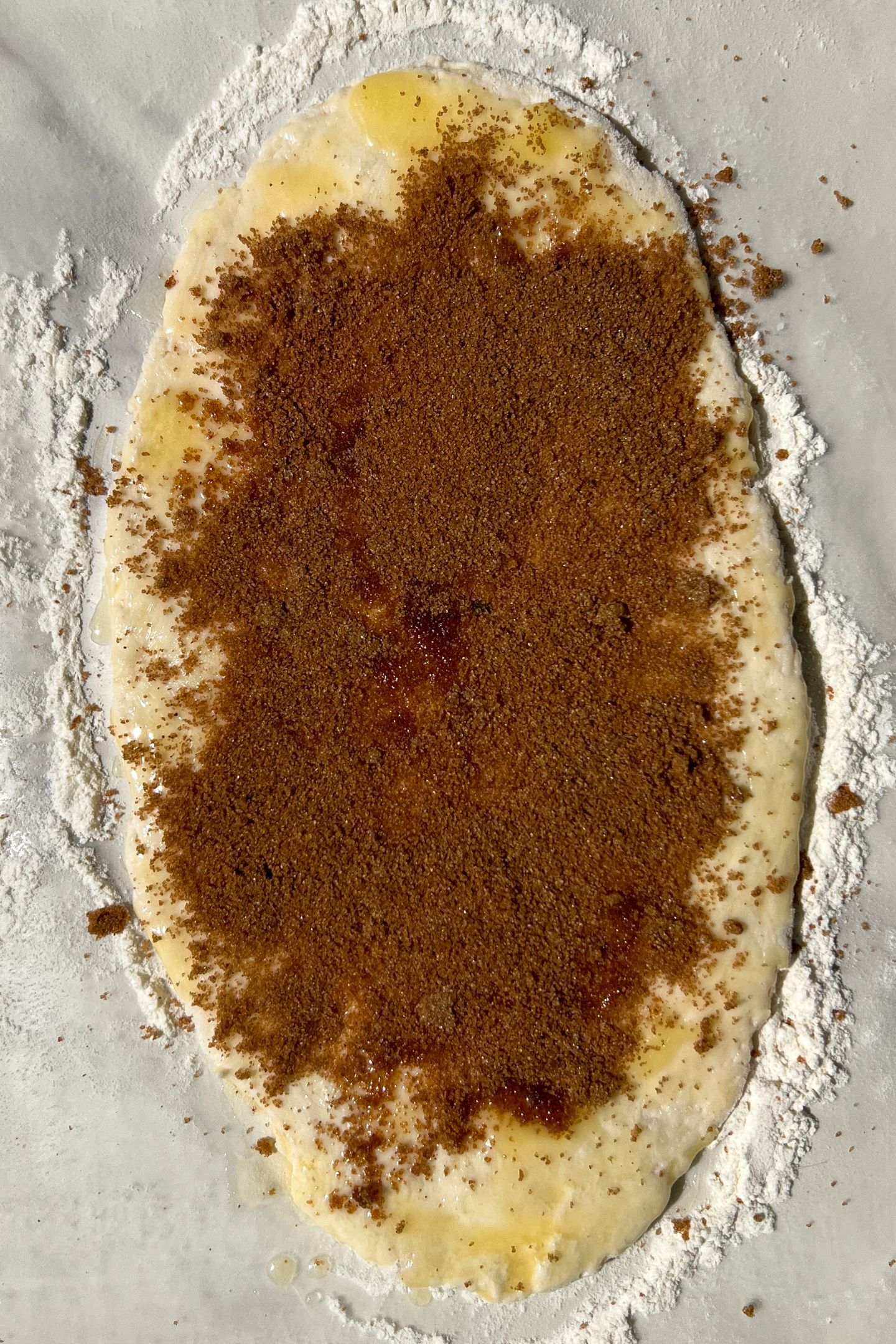 Dough rolled out topped with butter and cinnamon sugar mixture.