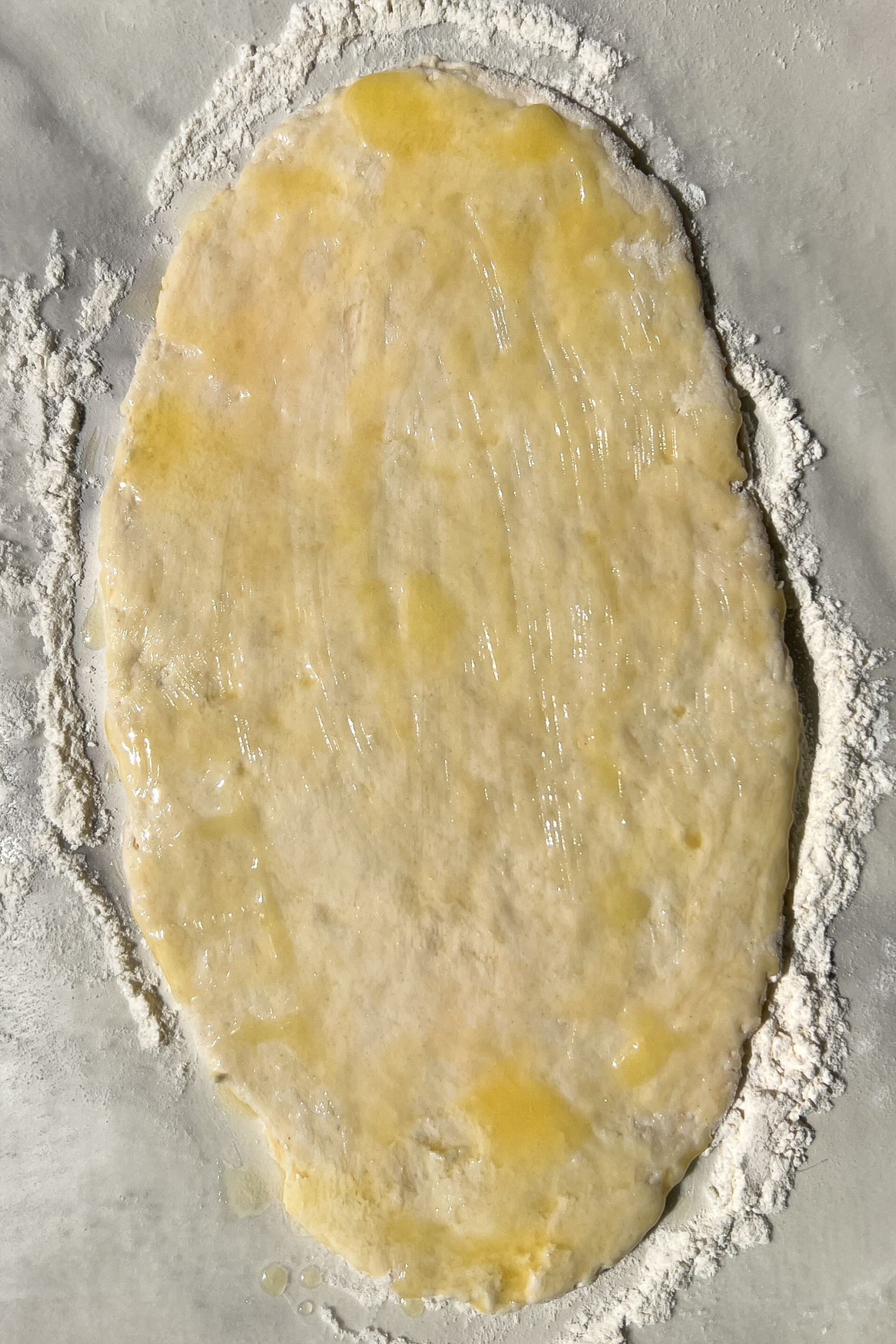 Dough rolled out and topped with butter.