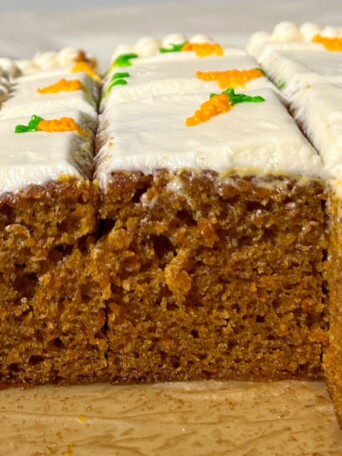 Sliced Mini Carrot Cake with carrot decorations.
