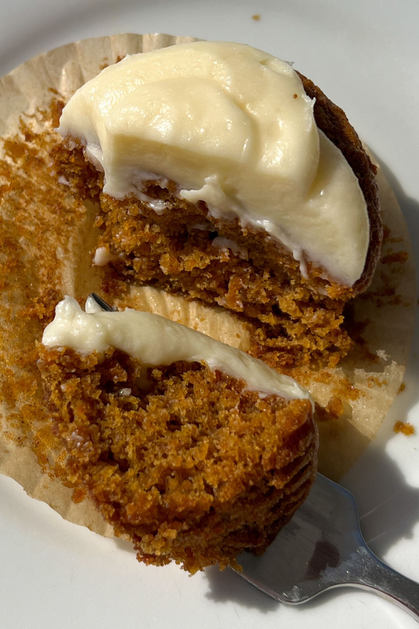 Eating a Gluten Free Carrot Cake Cupcake with a fork.