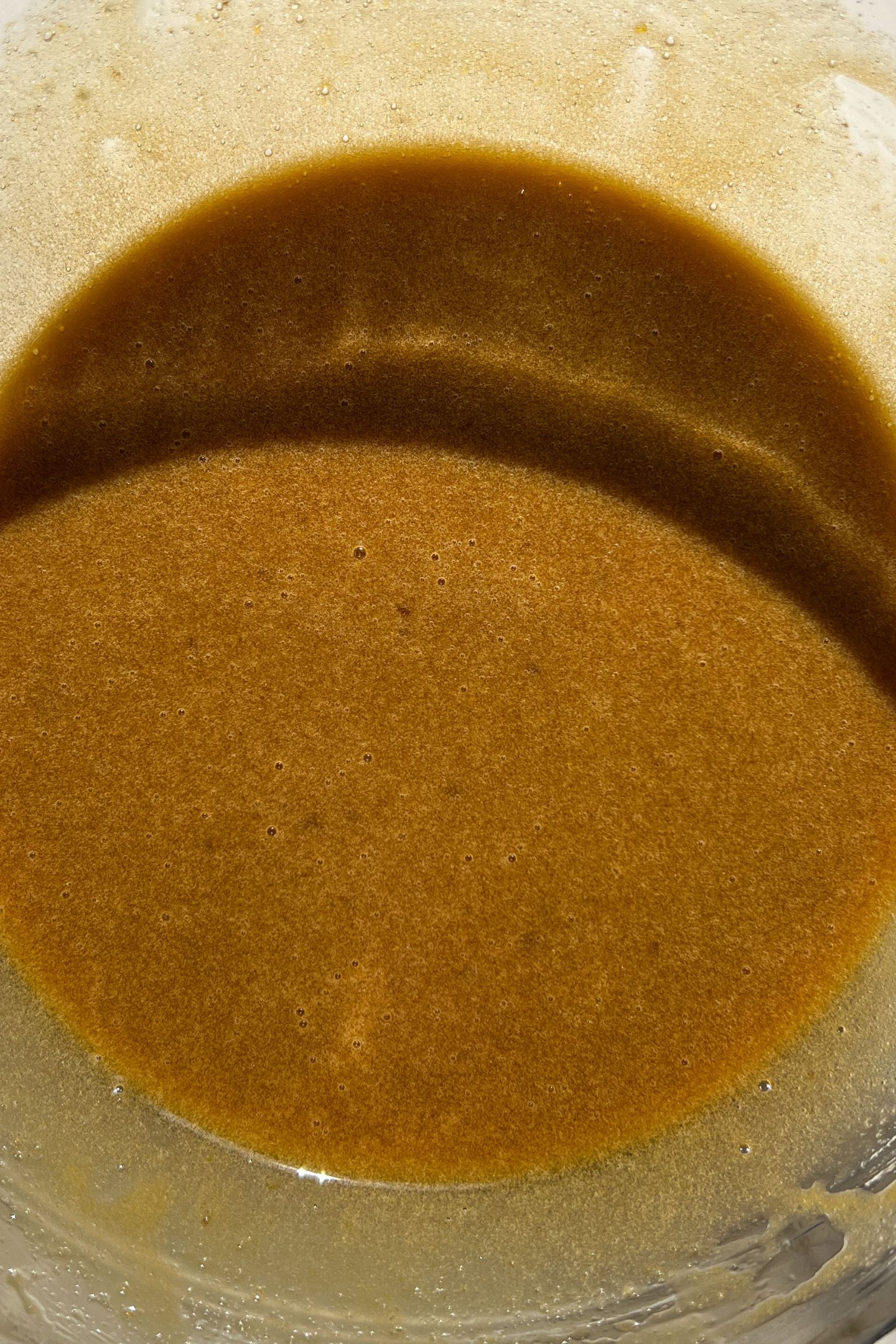 Wet ingredients in a mixing bowl whisked together.