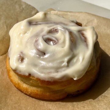 Protein Cinnamon Roll topped with a vanilla cream cheese frosting.