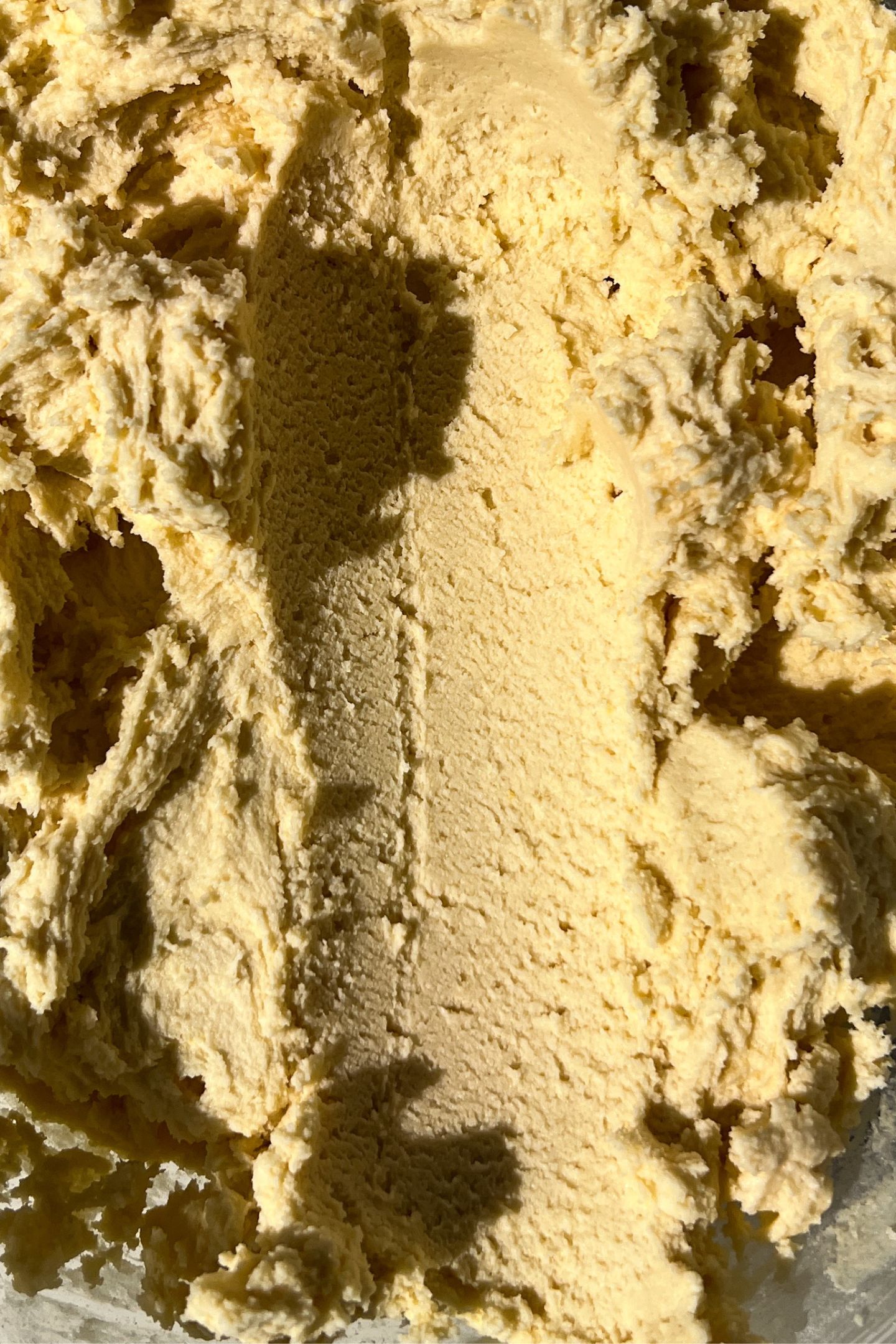 Scooping the dough from bowl.