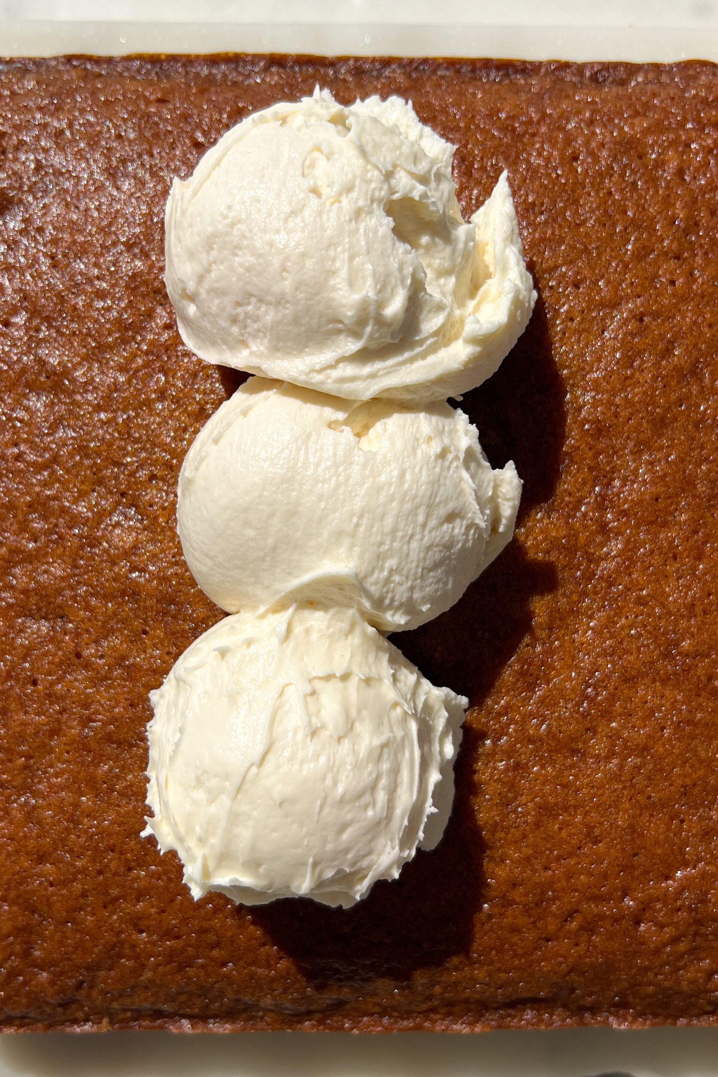 Adding frosting to cake.