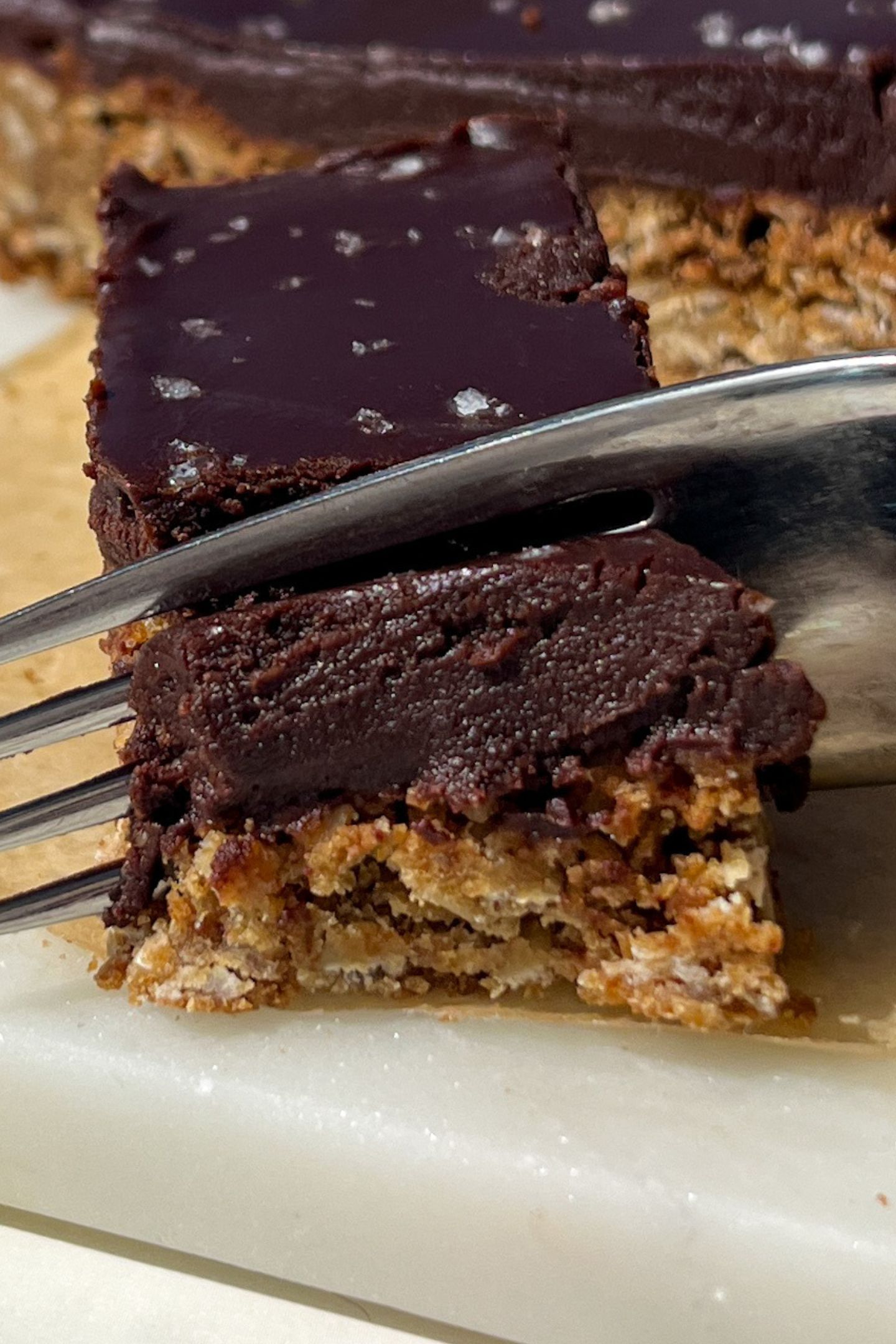 A fork cutting into a slice of the oat fudge bars.