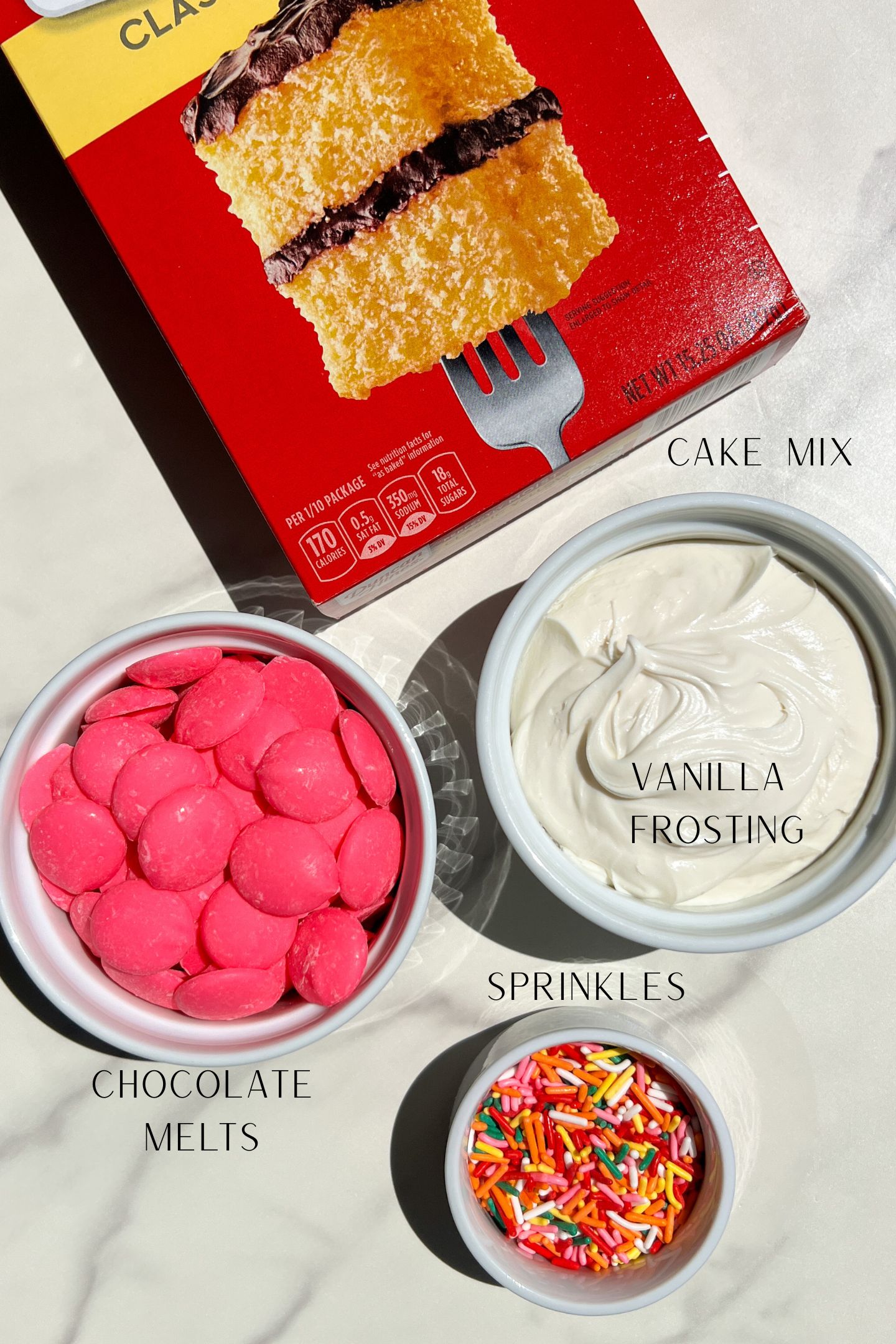 Cake pop ingredients measured out in bowls.