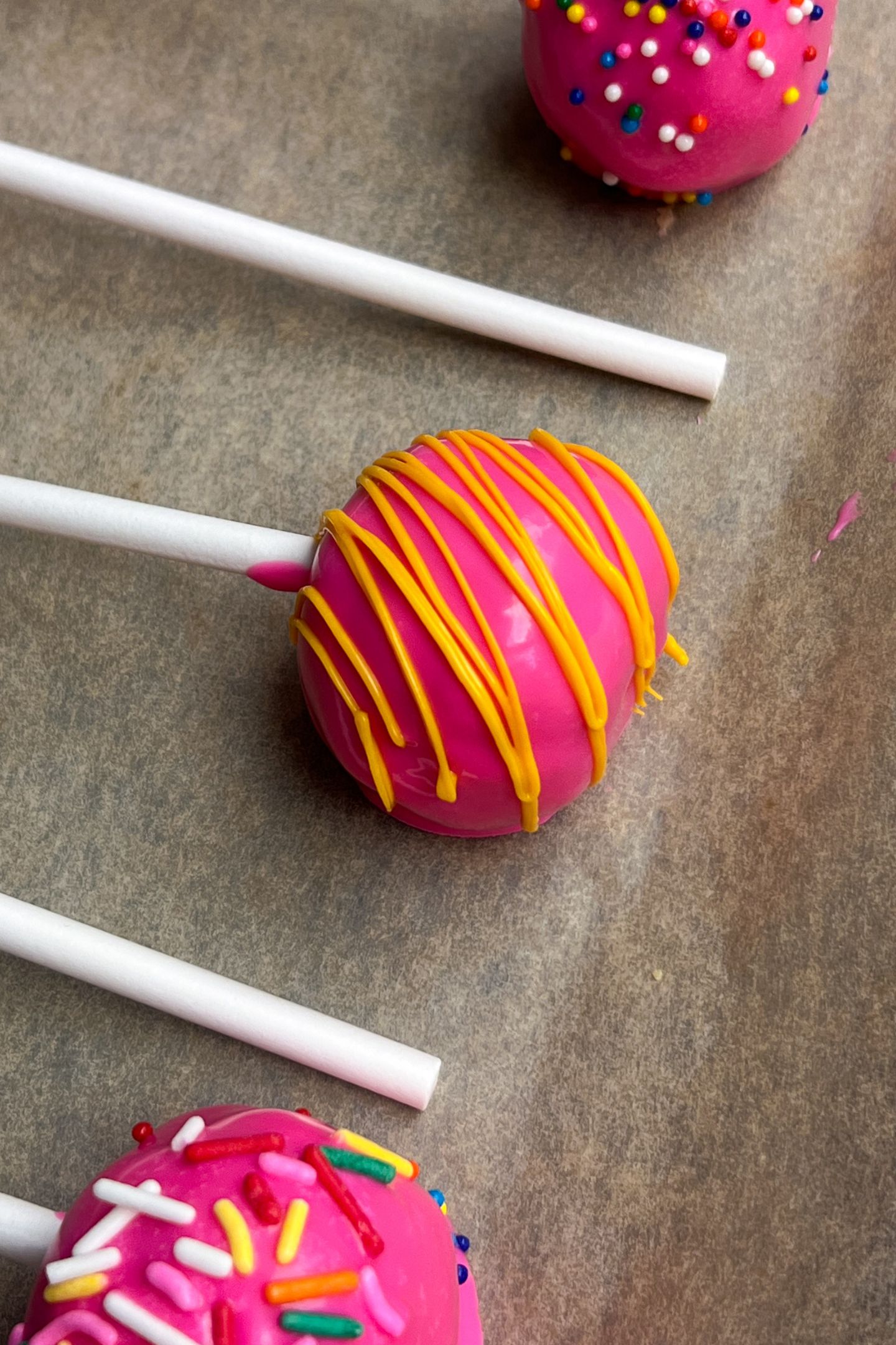Decorated cake pops on tray.