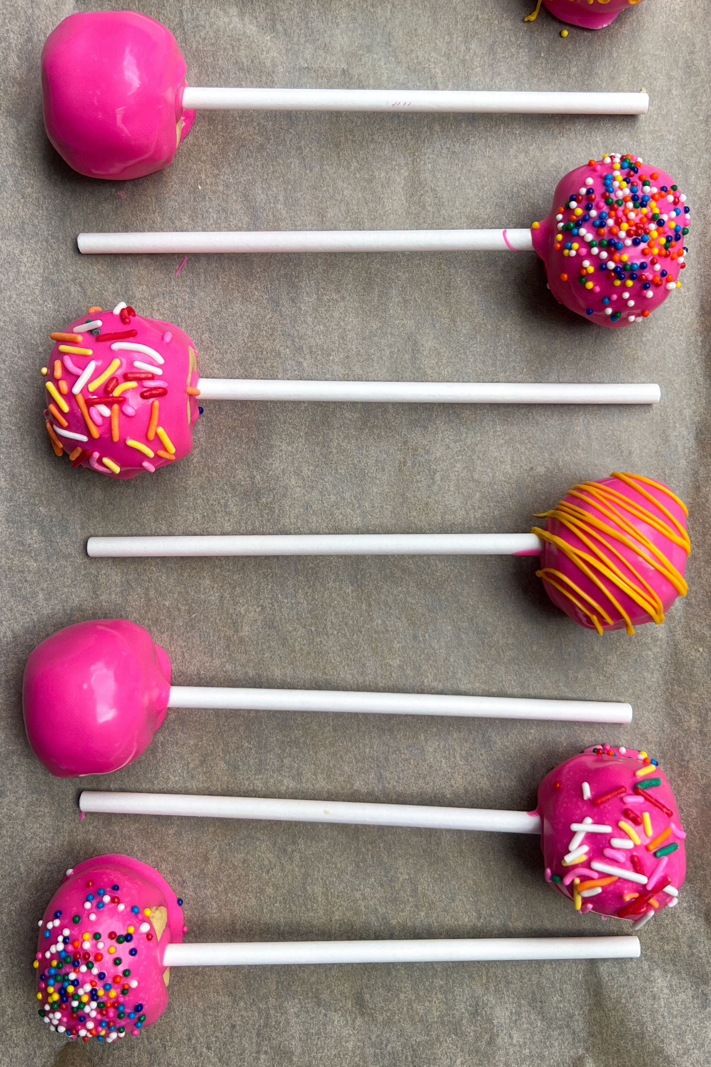 Decorated cake pops on tray.