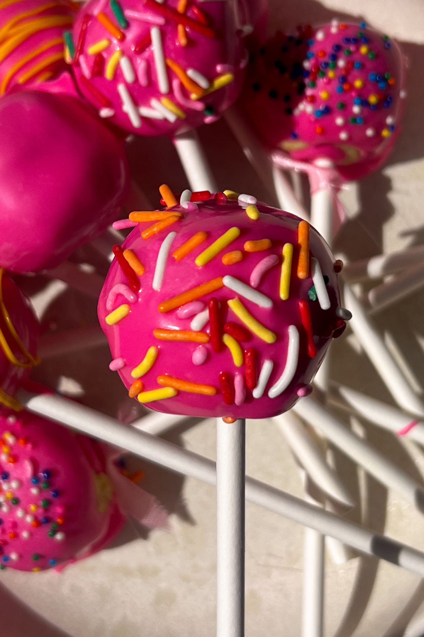 Holding a cake pop.