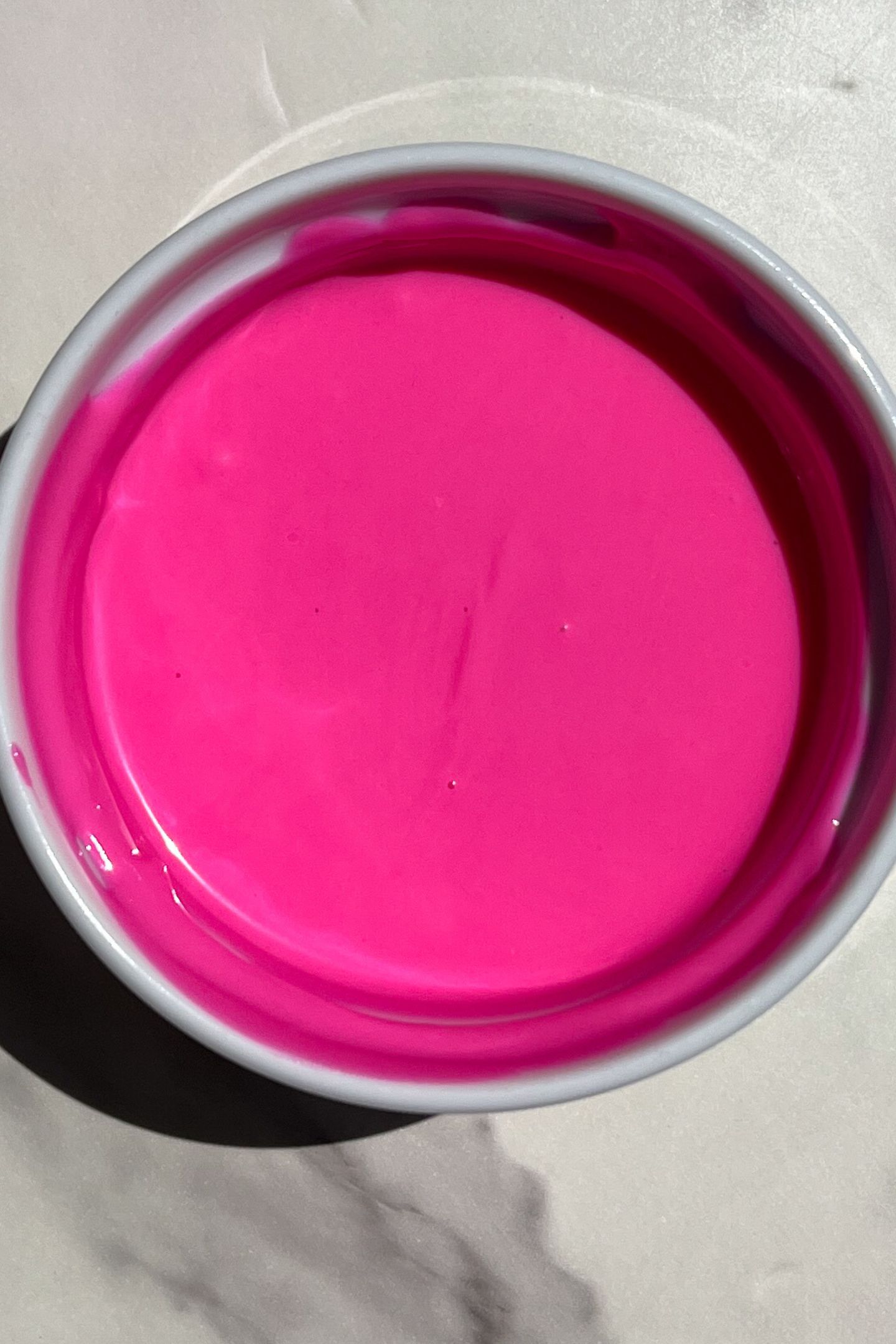 Melted pink candy melts in bowl.
