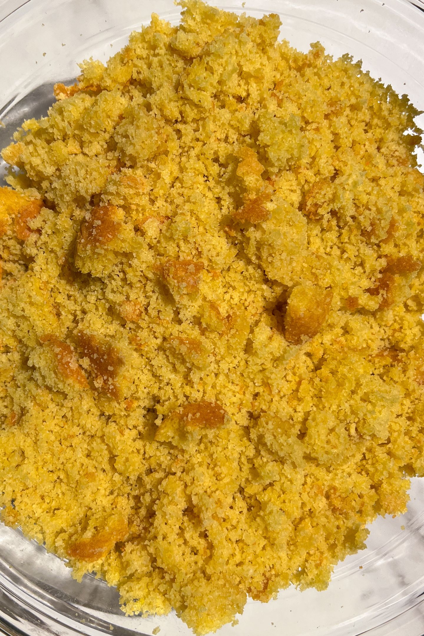Vanilla cake crumbled into a bowl.